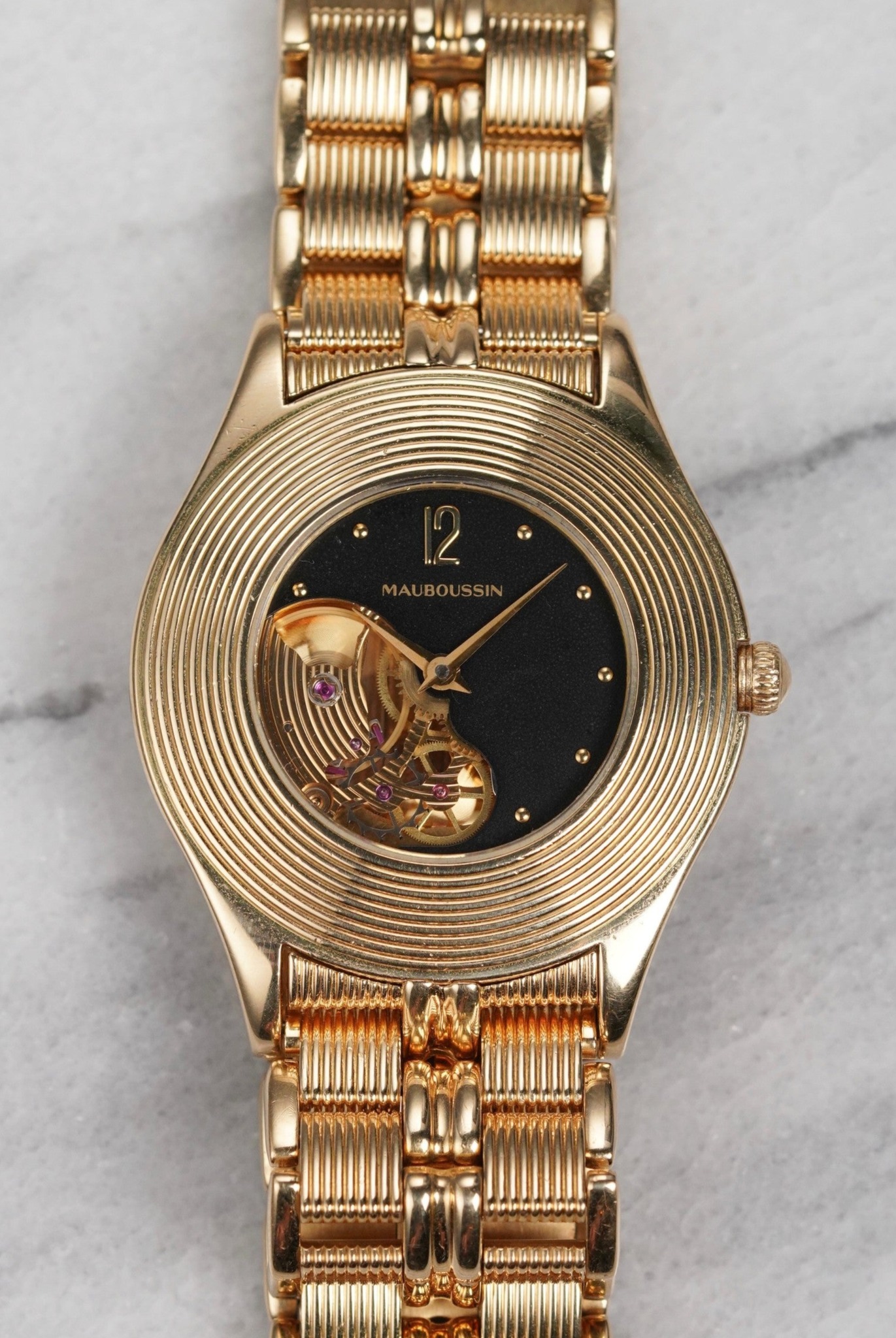 May be an image of wrist watch and text
