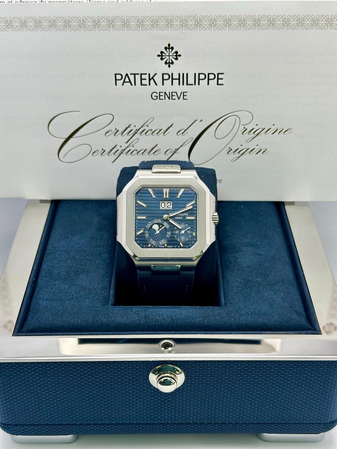 May be an image of wrist watch and text that says 'PATEKPHILIPPE PATEK PHILIPPE GENEVE Crafu Pertificat Dertificate Origine rigin 02 l ब'