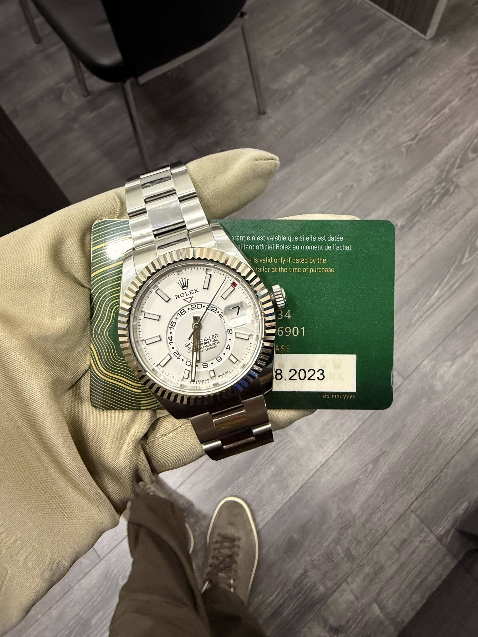 May be an image of wrist watch, wingtip shoes and text