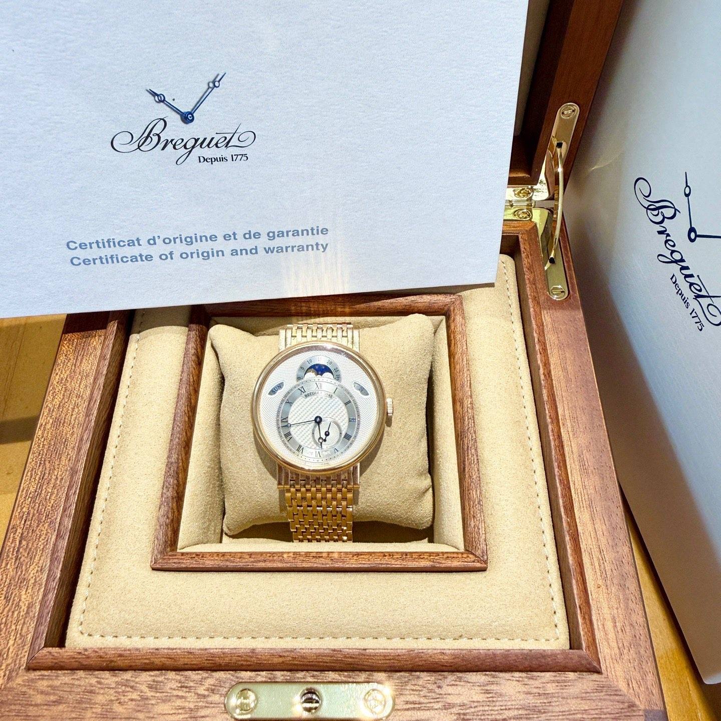 May be an image of wrist watch and text that says 'Bregueto 1775 Πeρ Certificat d'origlne et de garantie Certificate of origin and warranty हियव ဟ Breg Depais Breguele ist 1775'