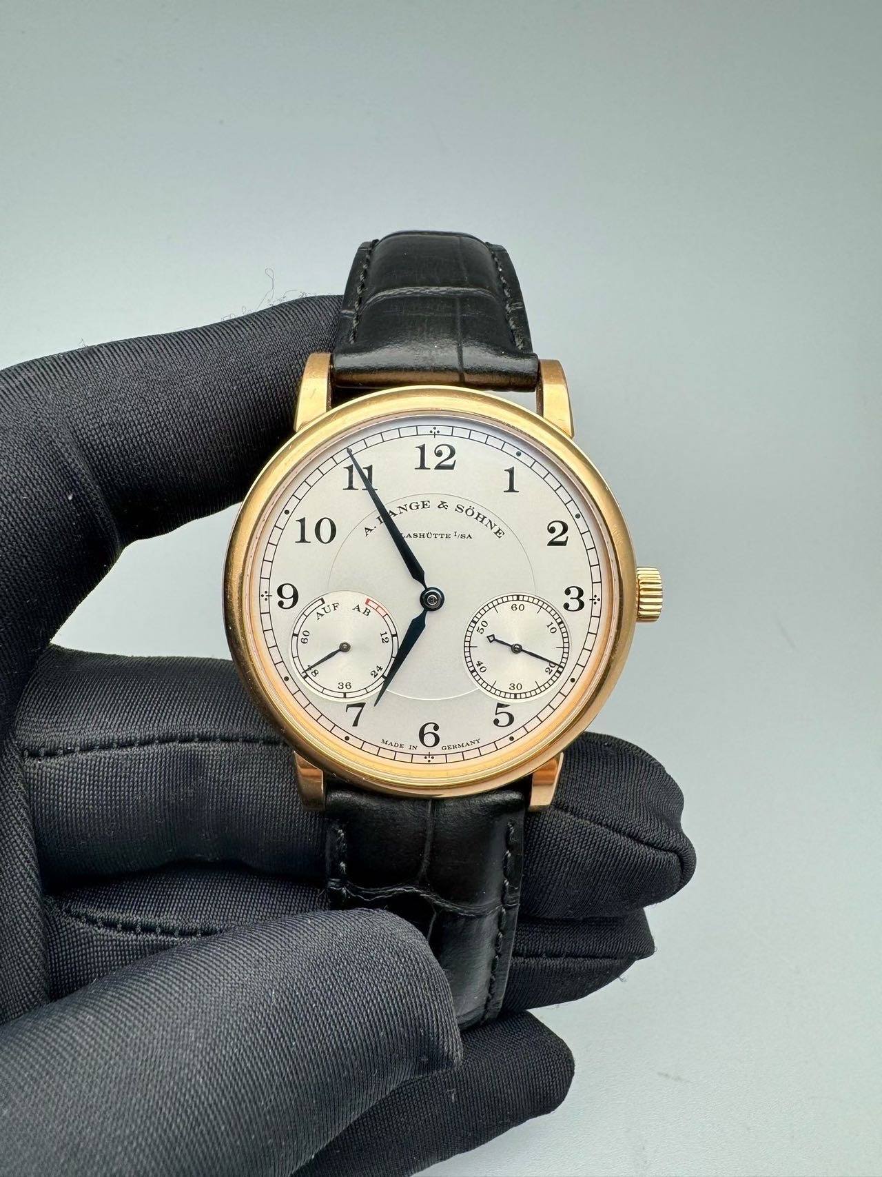 May be an image of leather, wrist watch and text