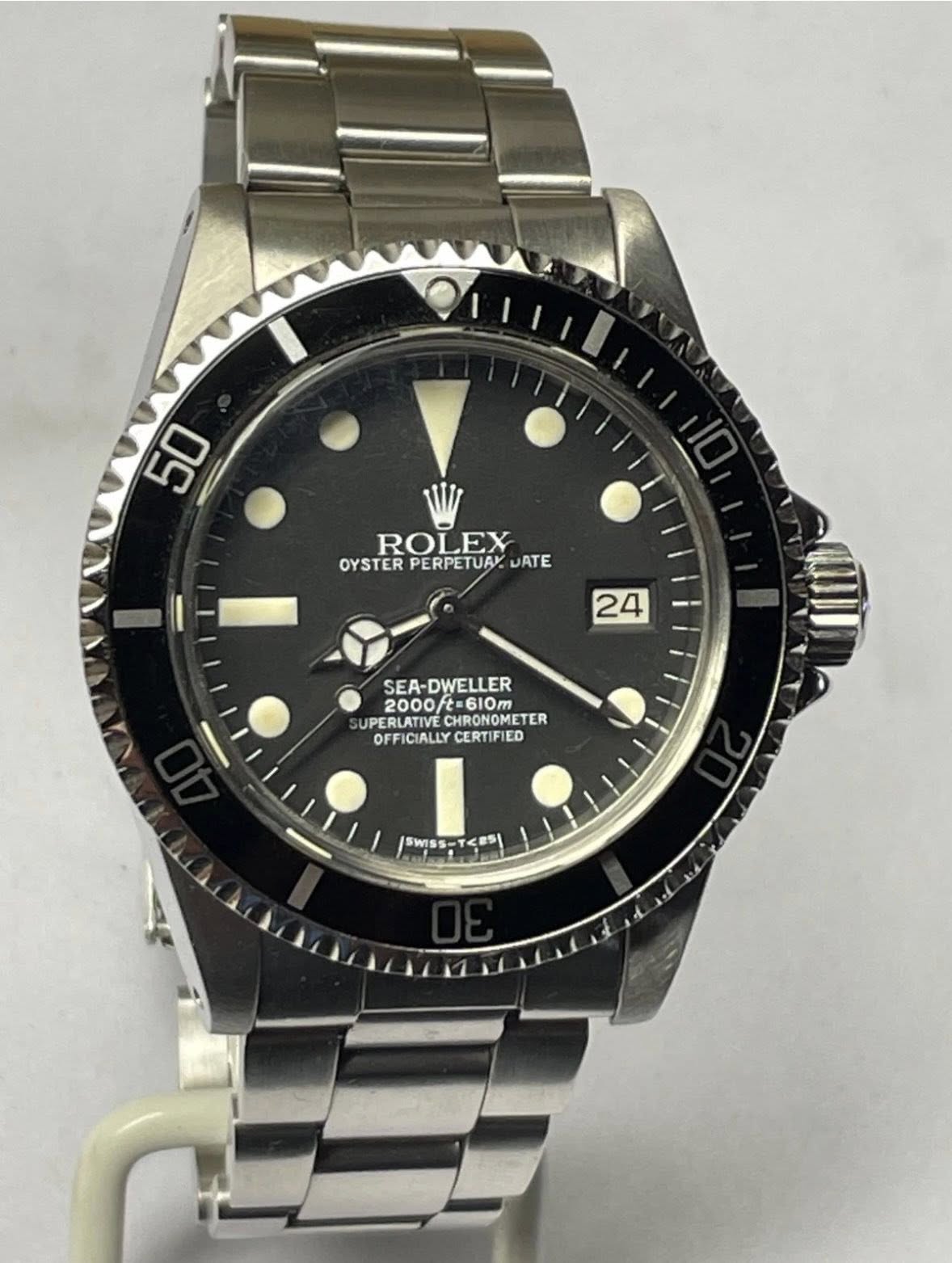 May be an image of wrist watch and text that says '50 ROLEX OYSTER PERPETUAY OYSTERPERPETUAY.UATE WATE 24 SEA-DWELLER 2000/t=610m t=610m 2000 SUPERLATIVE CHRONOMETER…