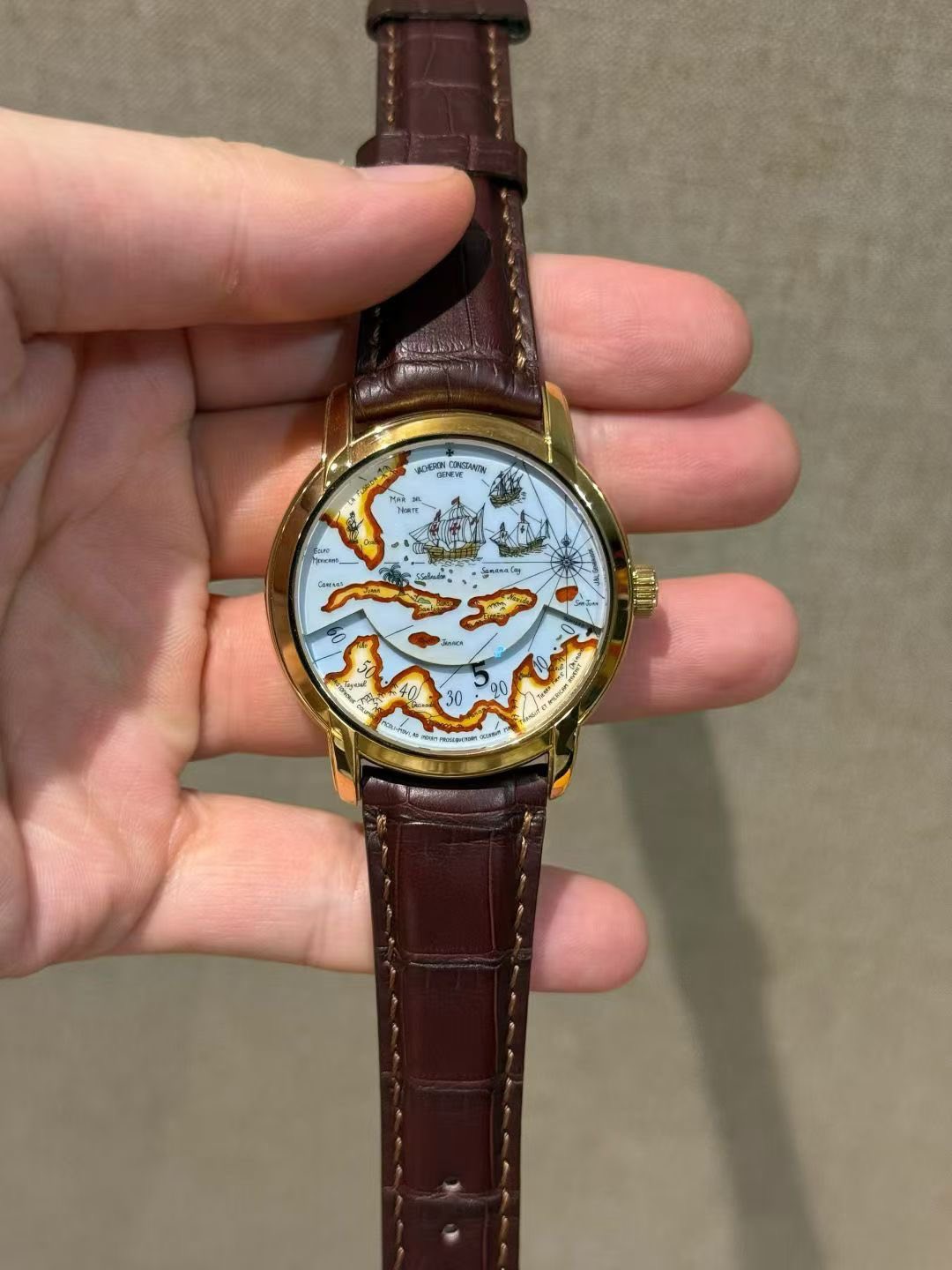 May be an image of wrist watch, map and text