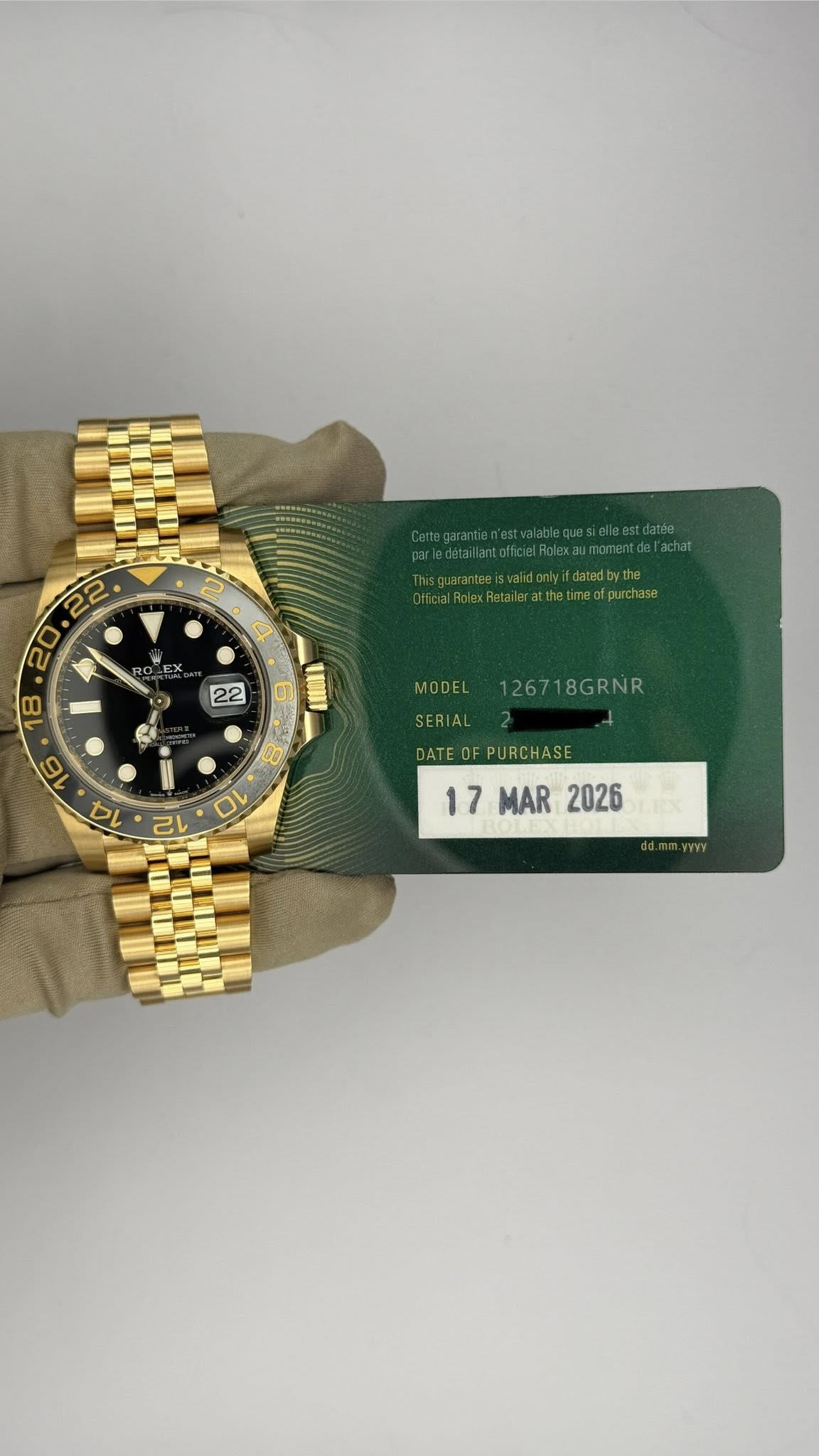 May be an image of wrist watch and text that says ' atthesimedlpurchase 22 و LHI MODEL 126718GRNR SERIAL DATE DATEOFPURCHASE 17 17MAR MAR2026 MAR 2026'