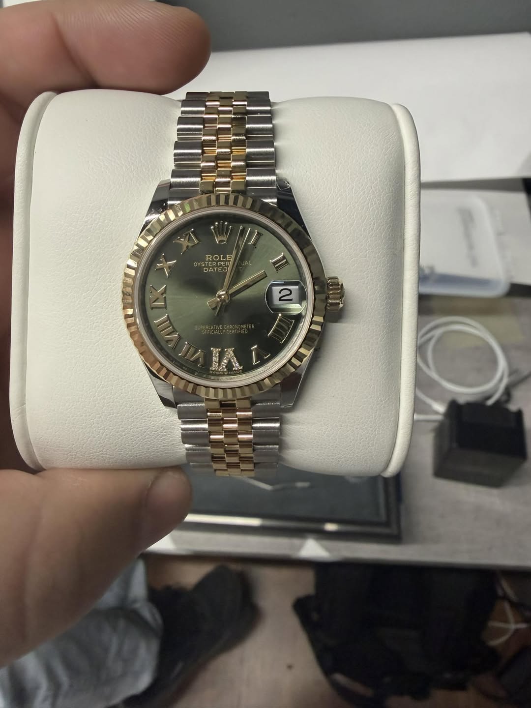 May be an image of wrist watch and text