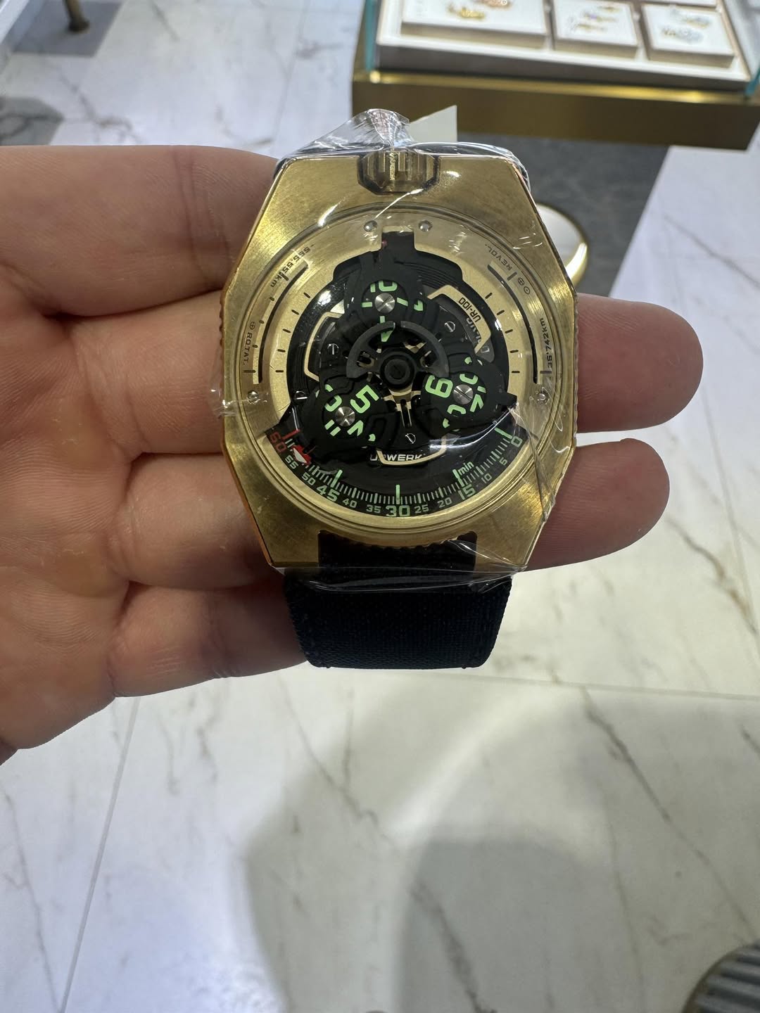 May be an image of wrist watch and text