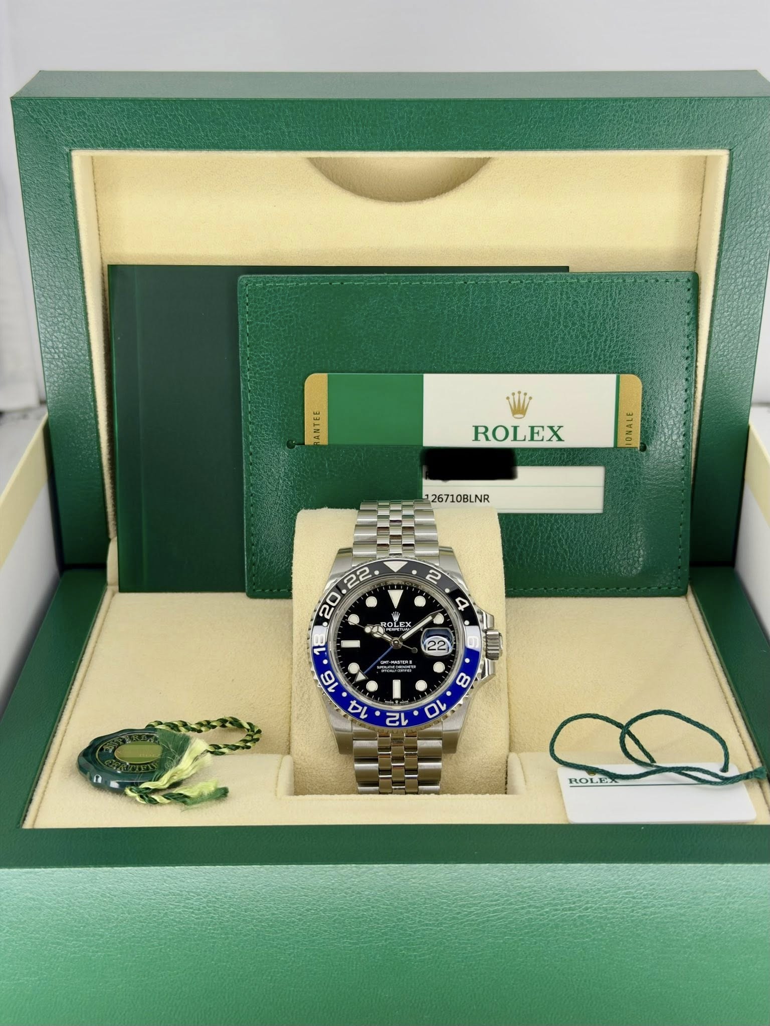 May be an image of wrist watch and text that says 'E H3INYE ROLEX 126710BLNR AE ירייל ROLE ROLEX'