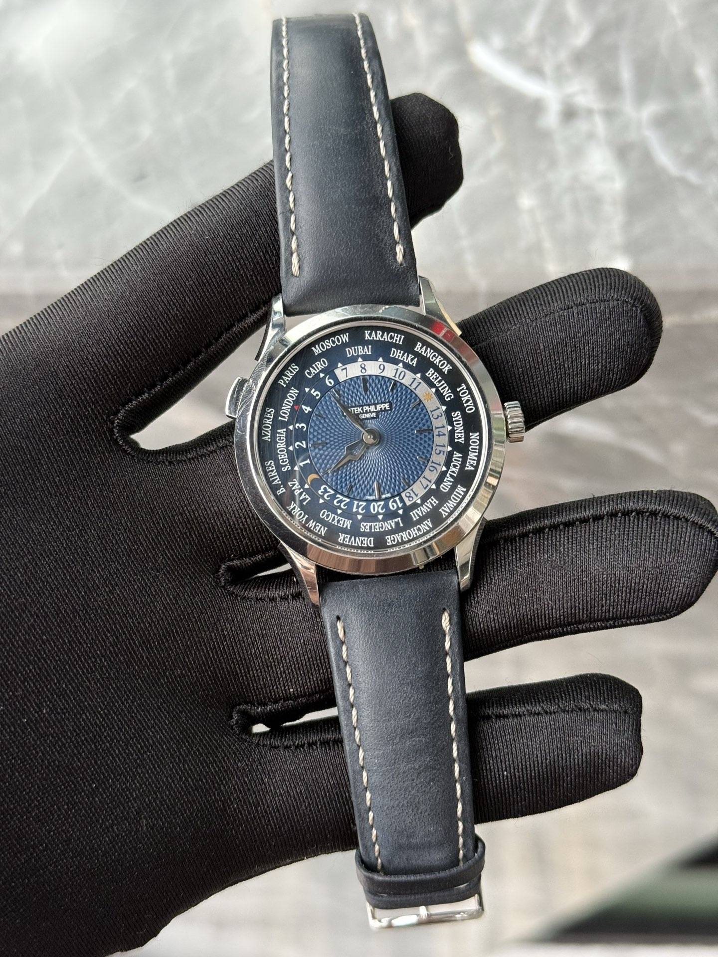 May be an image of leather, wrist watch and text