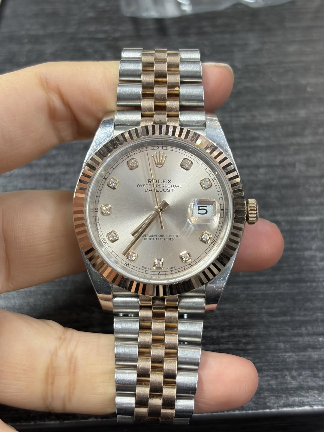 May be an image of wrist watch and text