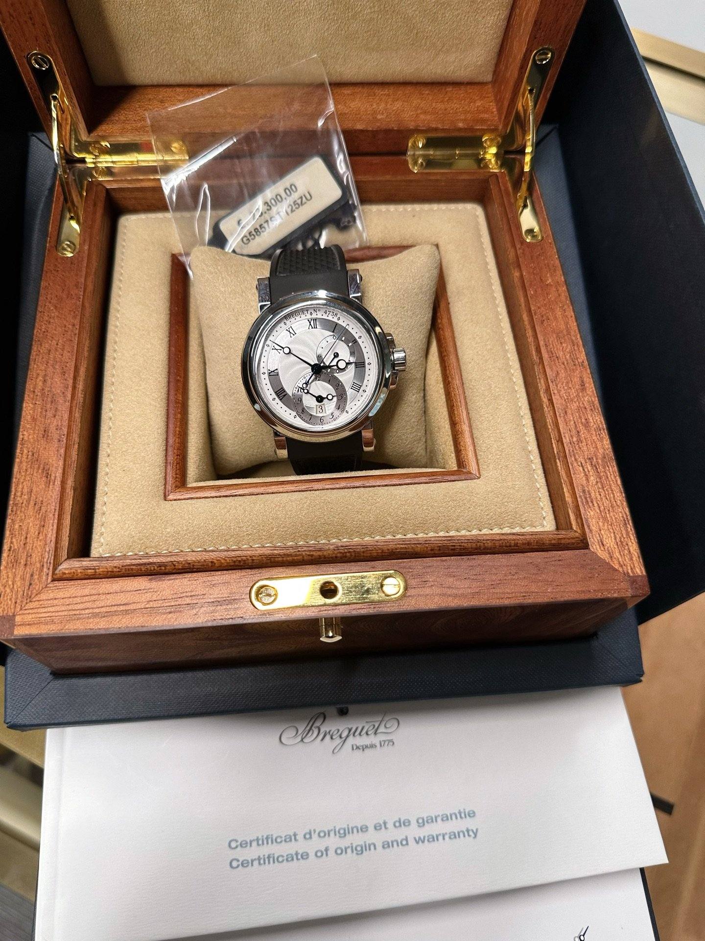 May be an image of wrist watch and text that says '0.300,00 G5857.300,00 257L 25ZU G5857 ST 方 M Orequelo 1775 Aepab Certificat Certificate of origin and warranty d'origine et de…