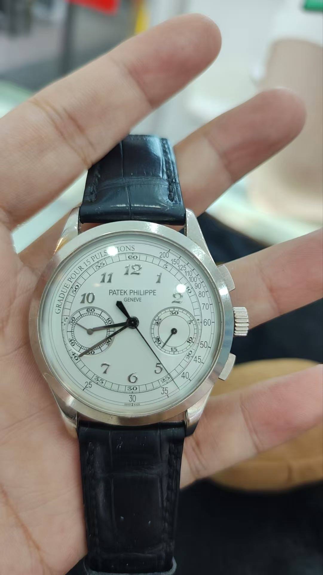 May be an image of wrist watch and text that says 'IONS G0 12 200 PULS POUR PATEKPHILIPPE PATEK PHILIPPE GENEVE GR GRADUE 50 mamdr tko جان 60 S0 504 ه RAD '