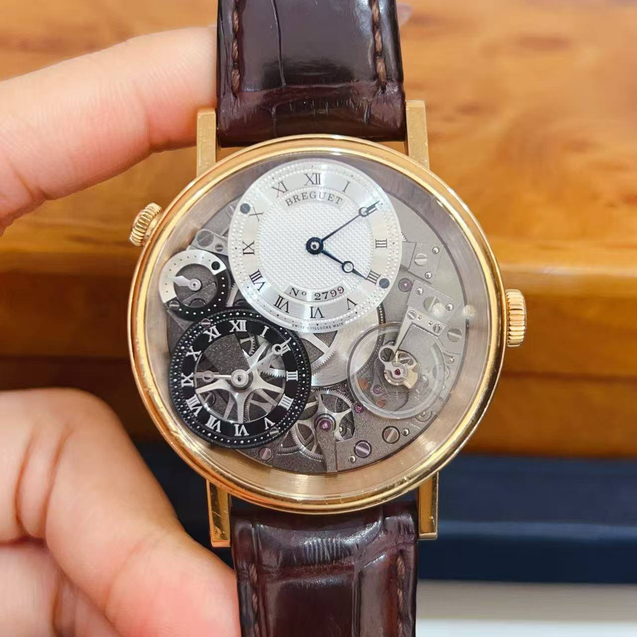 May be an image of wrist watch and text that says 'XI XII BREGUET അഗ ل IX o II O E No 2799 Δ IA メ 日 XI XI 士 IX VI Sy 7 S 京 三 A S'