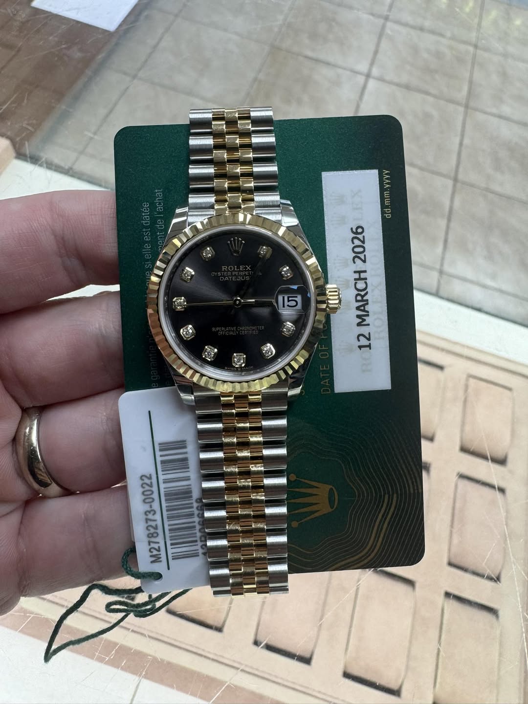 May be an image of wrist watch and text that says 'EX mm.yyvy dd 2026 የውወ MARCH 12 RE 5 M278273-0022'
