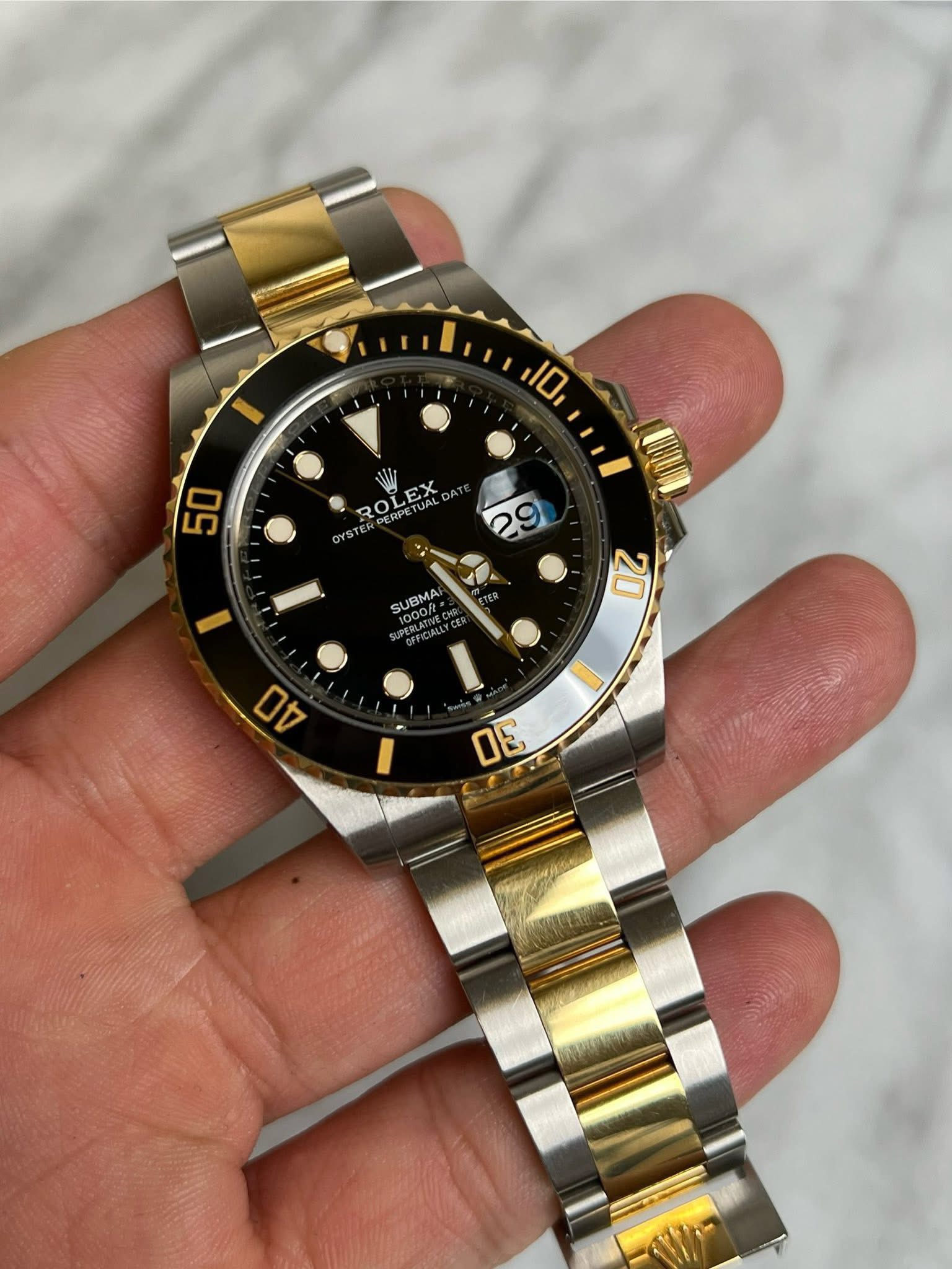 May be an image of wrist watch and text that says '10 50 ROLEX EX SUBMA 100 1000/ ERLATN 20 ዐ DE'