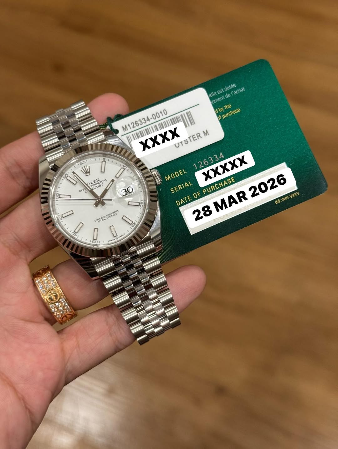 May be an image of wrist watch and text that says 'elle est datée achat orent 0e by purchase W PE LEPE LE TUAL 原ケスア SUST ๙ OrDH 30 M126334-0010 XXχχ UYSTER M 126334 XXXXX…
