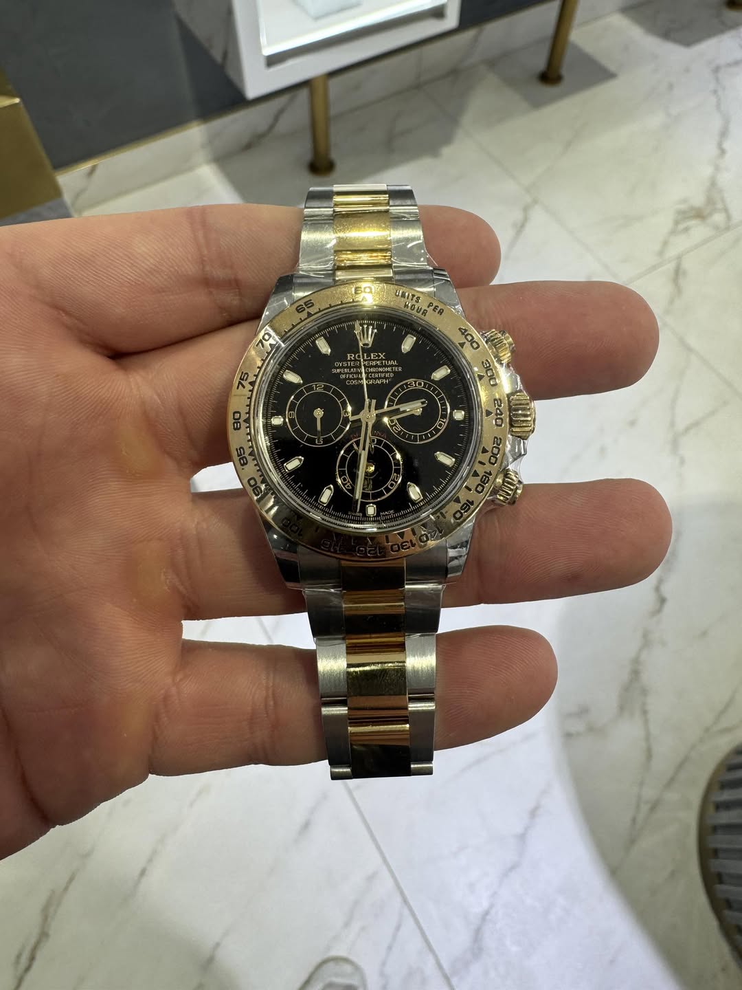 May be an image of wrist watch and text