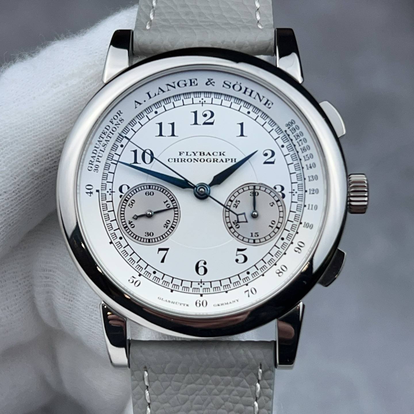 May be an image of wrist watch and text that says 'LANGE & D SÖHNE A. 12 GRADUATED m ய.யய FLYBACK CHRONOGRAPH 60 50 10 U 25 4 ส O mm mmm m GLASNETT mm 70 60 GEHMANY'
