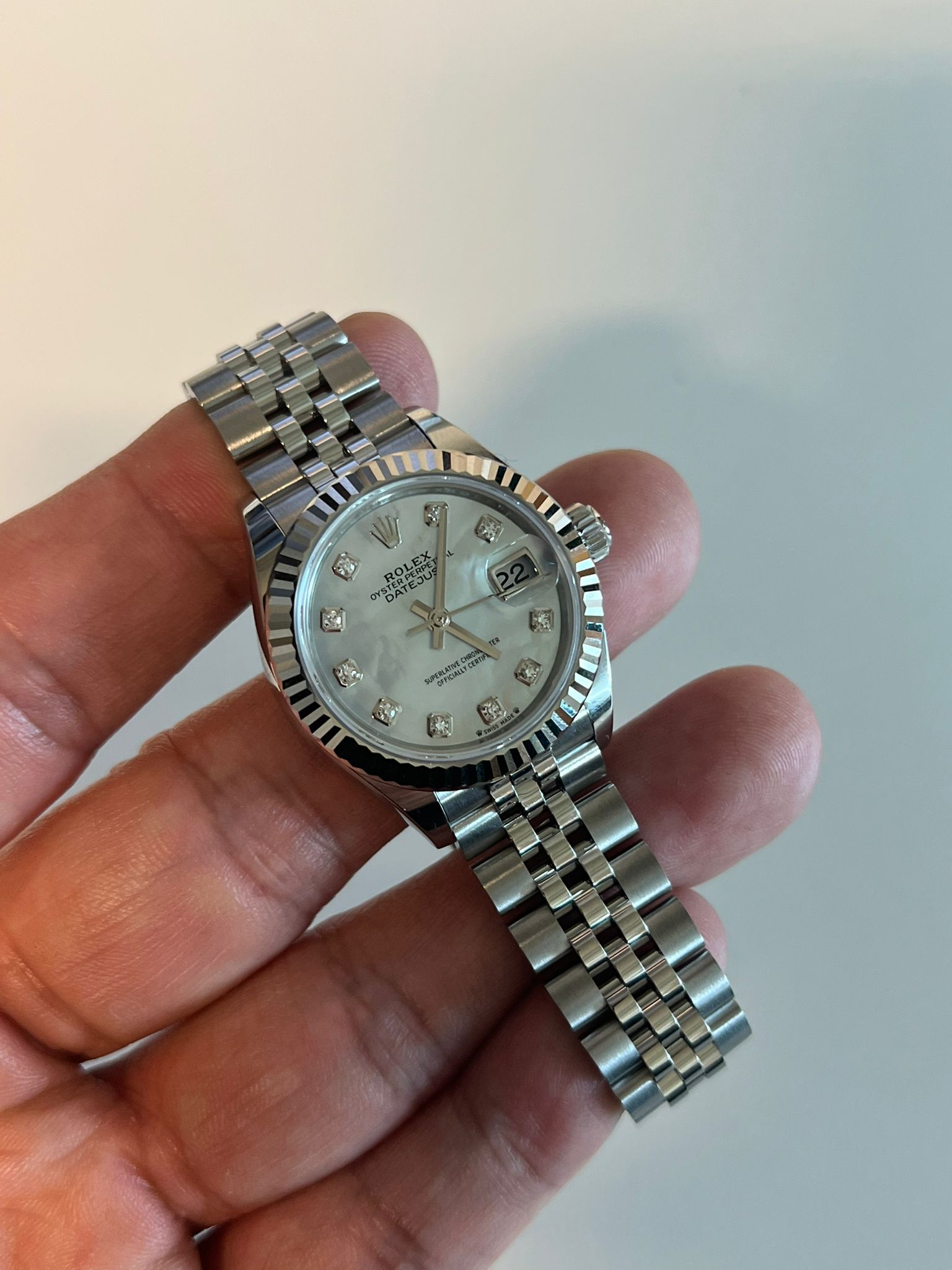 May be an image of wrist watch and text that says 'M W'