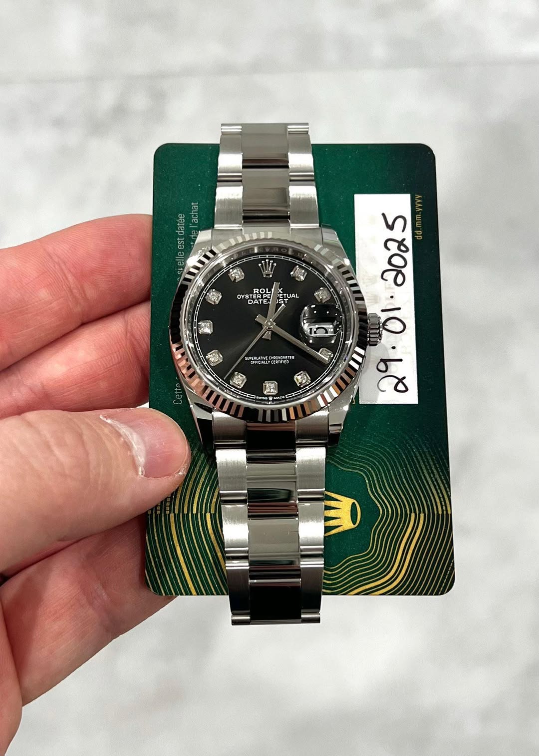 May be an image of wrist watch and text
