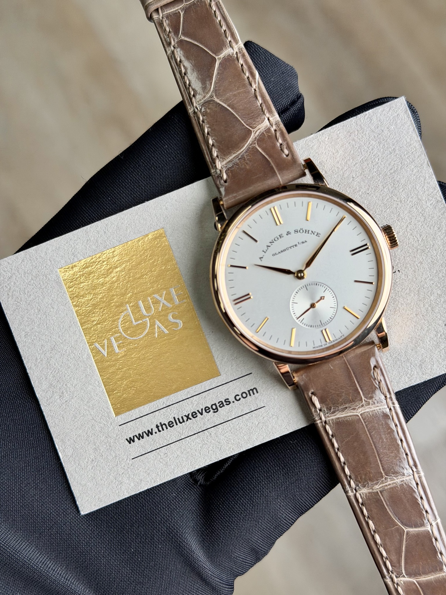 May be an image of wrist watch, leather and text