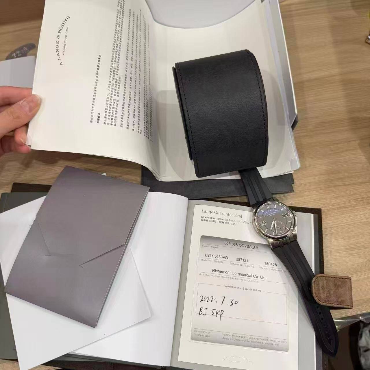 May be an image of leather wallet, saddle-stitched leather, leather, wrist watch and text