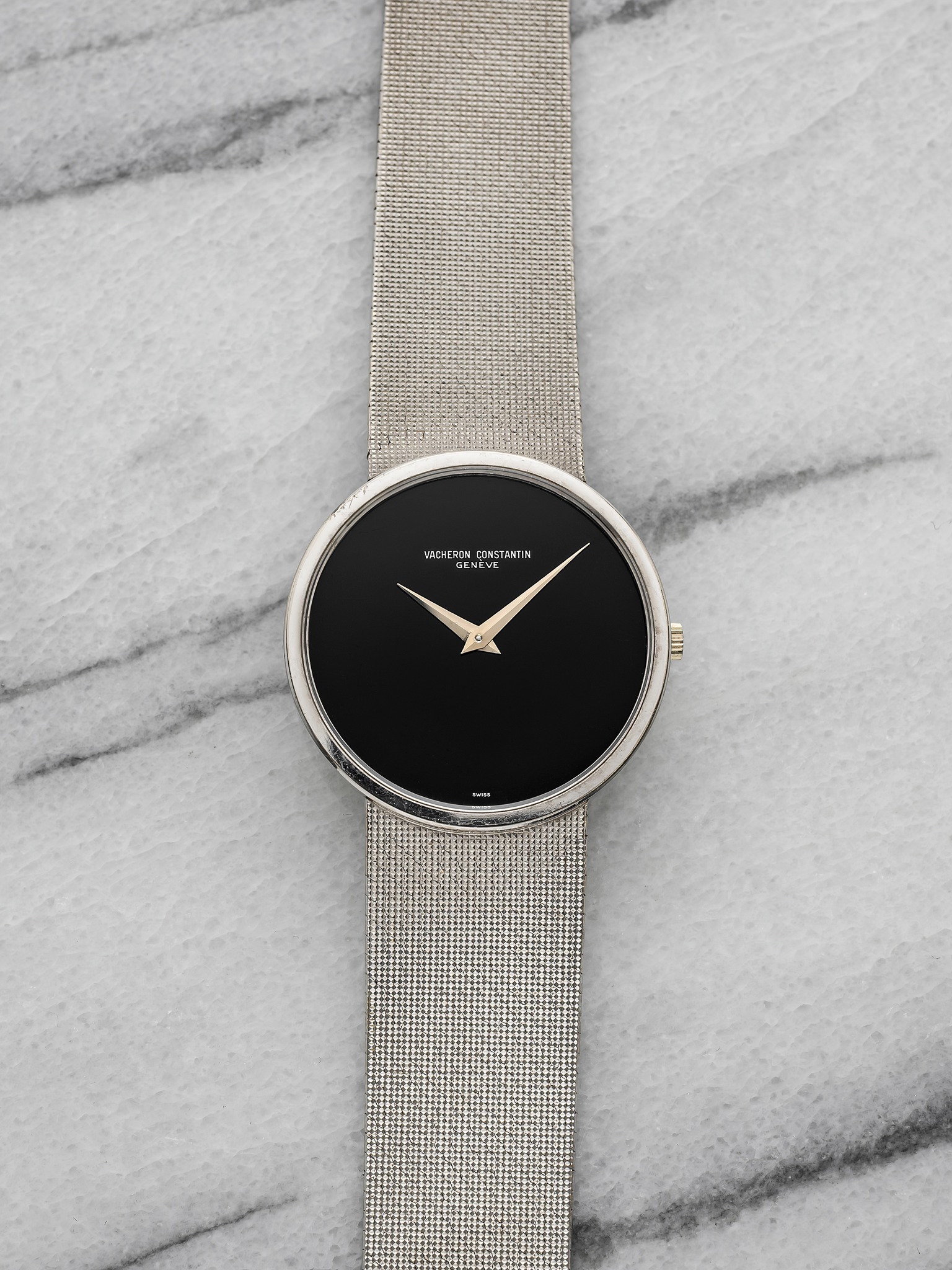 May be an image of leather, wrist watch and text
