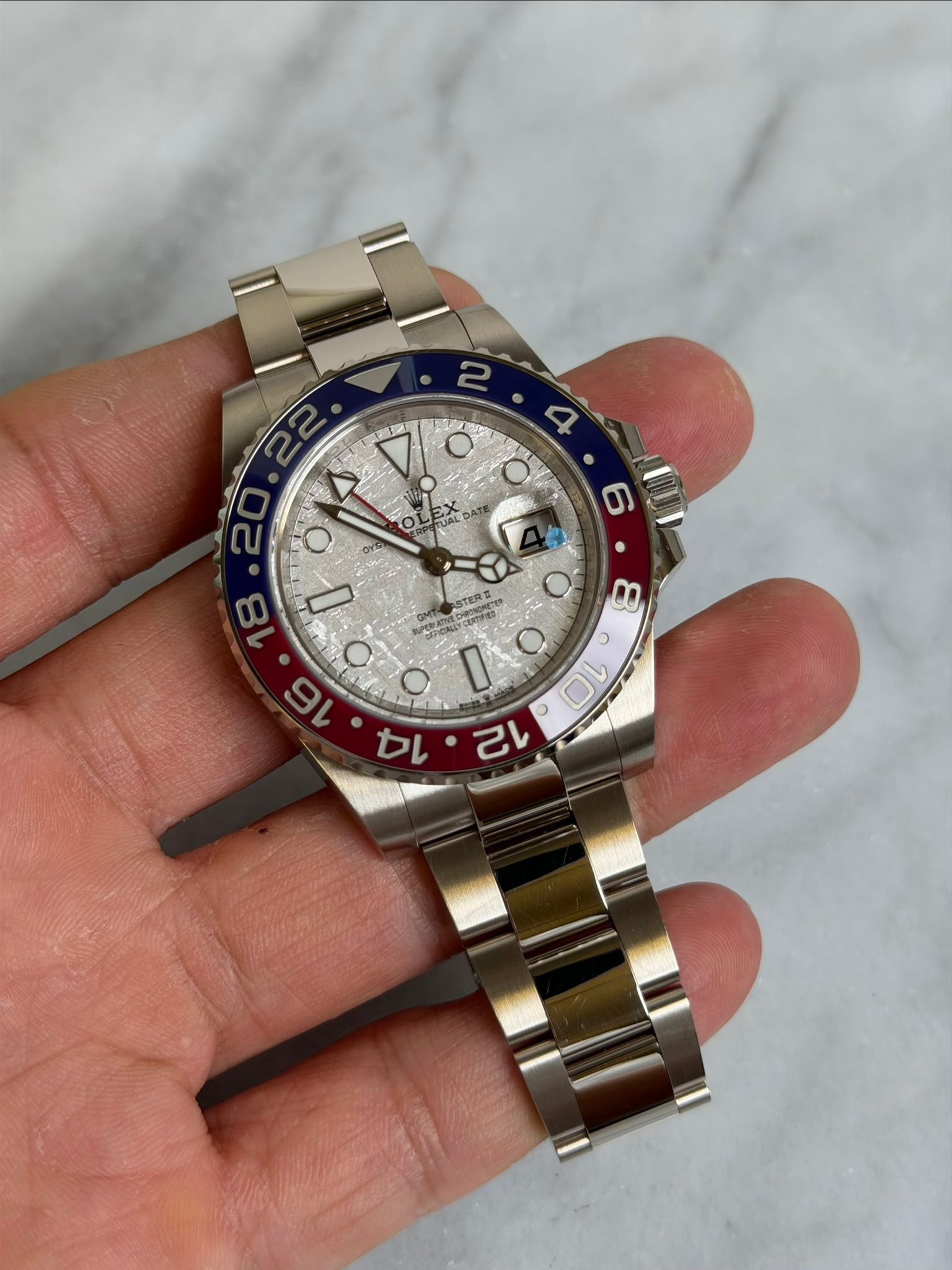 May be an image of wrist watch and text