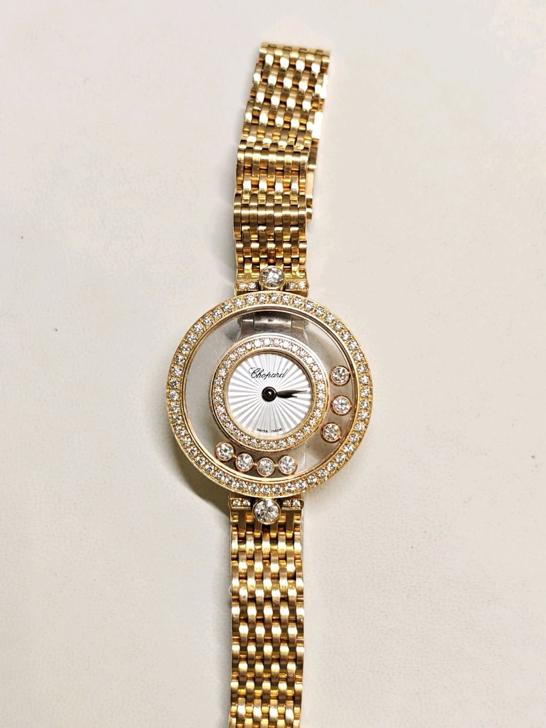 May be an image of jewelry, wrist watch and text