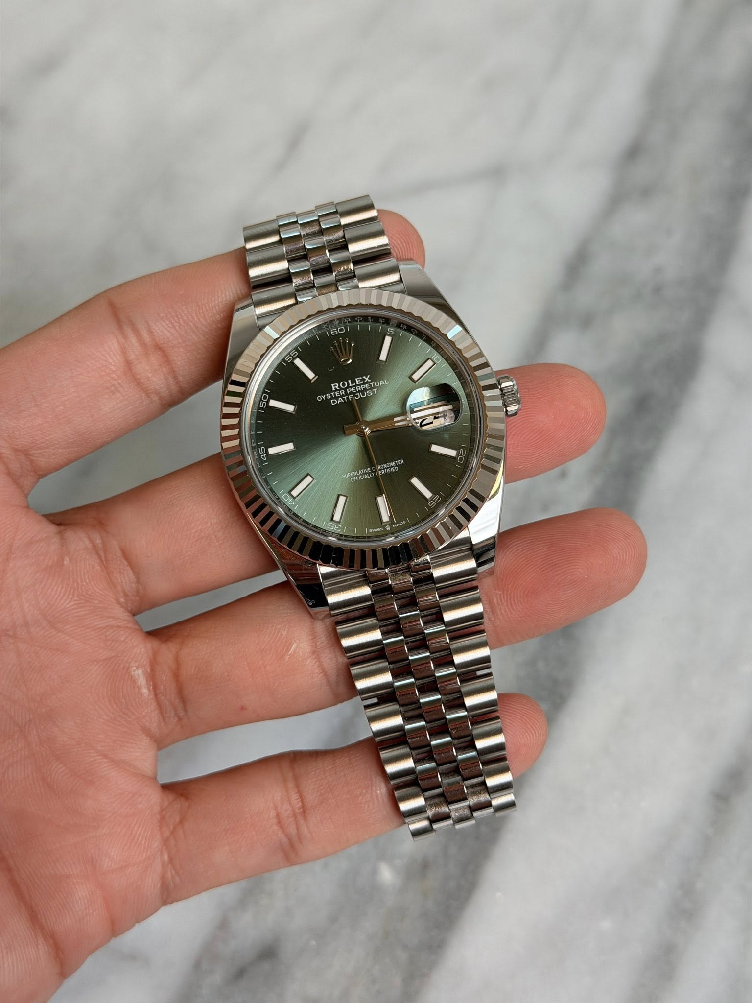 May be an image of wrist watch and text