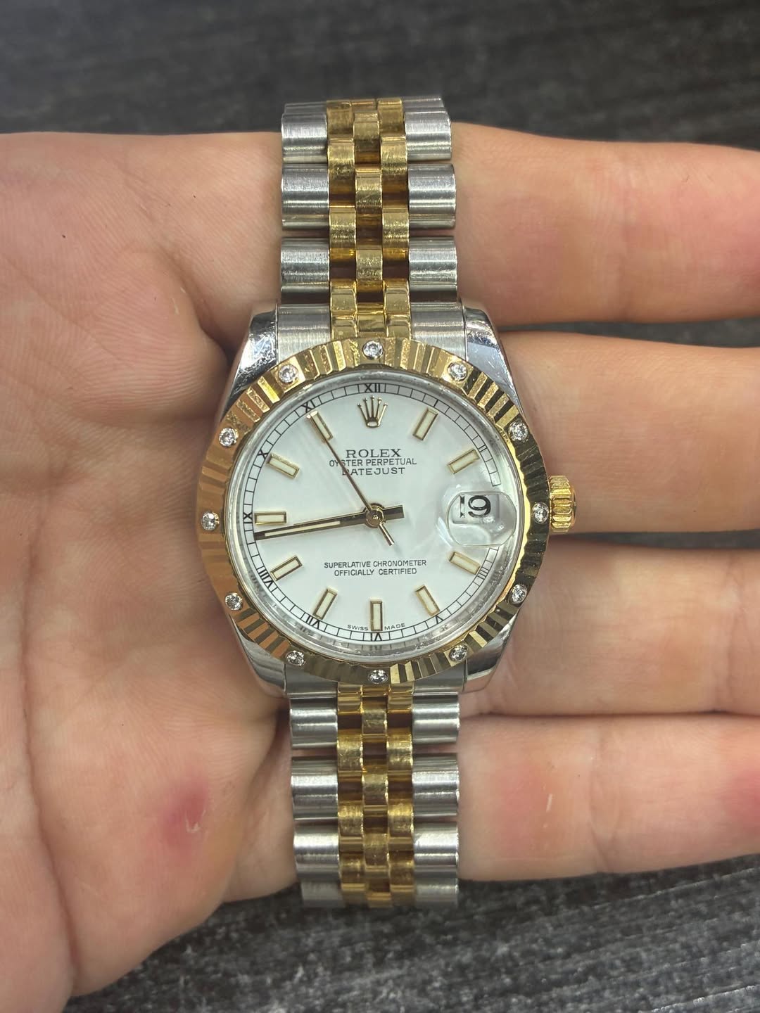 May be an image of wrist watch and text