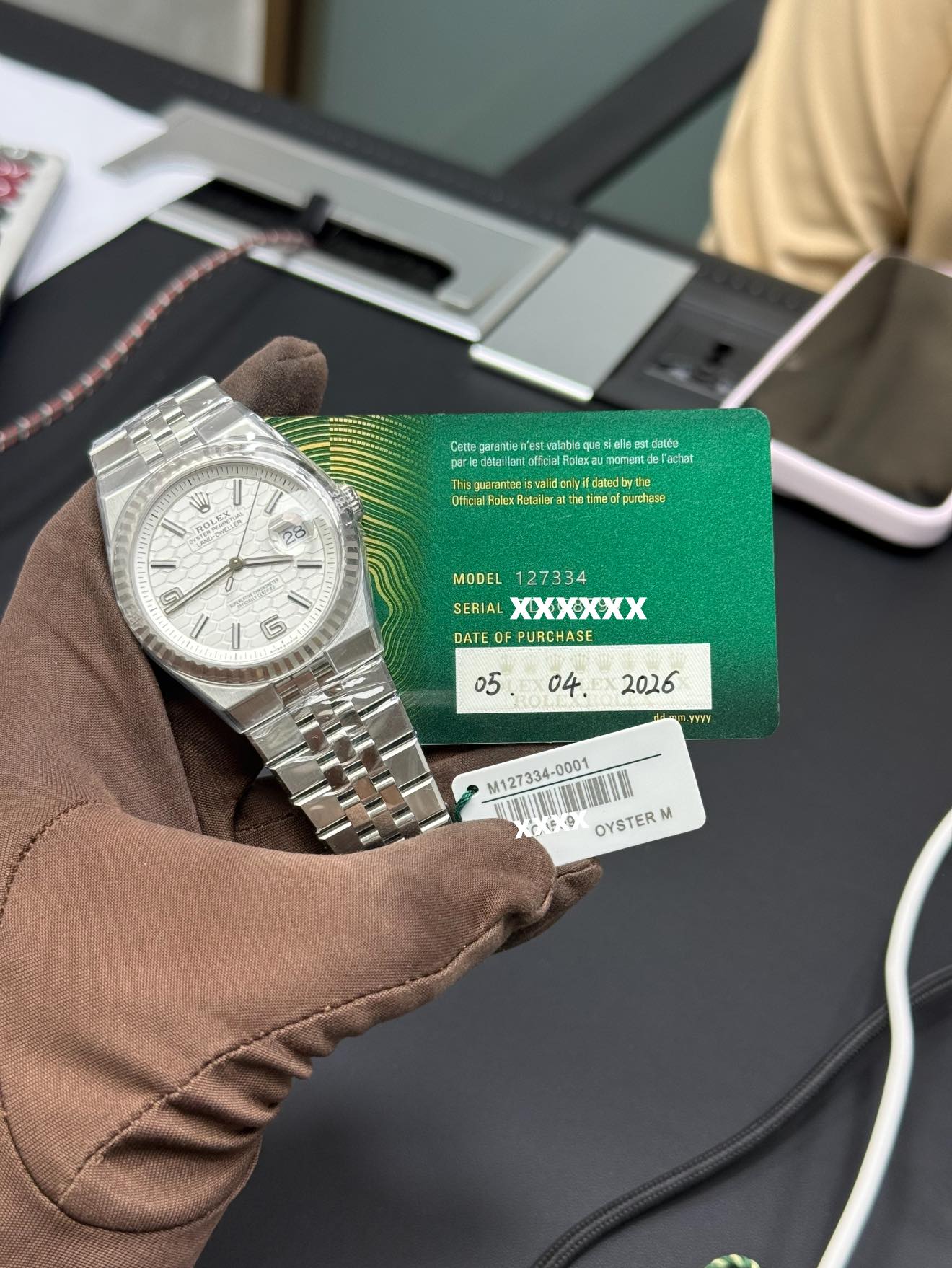 May be an image of money, wrist watch and text