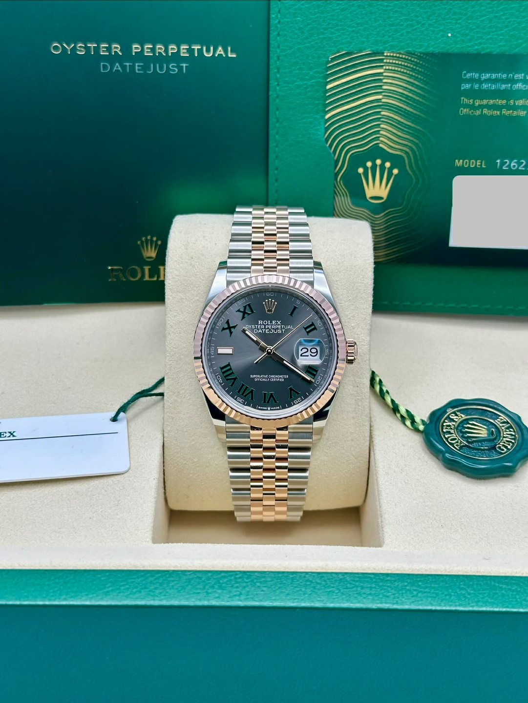 May be an image of wrist watch and text that says 'OYSTER YSTERPERPETUAL PERPETUAL DATEJUST Cette garantie est par detallantaffici detaillant Thisguarantee vali vght Ofieial…