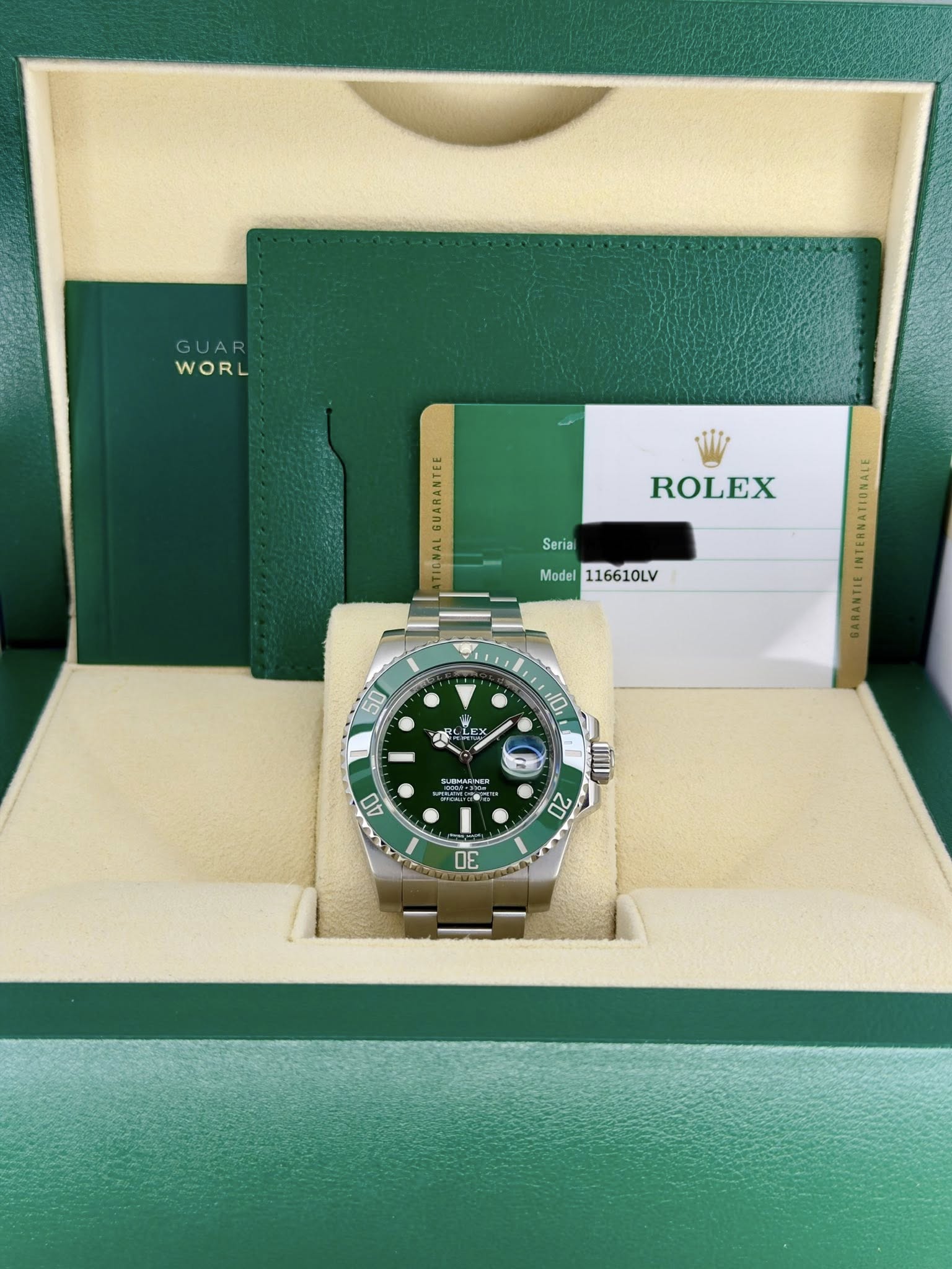 May be an image of wrist watch and text that says 'GUAR WORL w WORL ROLEX Serial TIONAL Model 116610LV 50 E E KX 10 人 EMREIES eaR- 40 20 V'