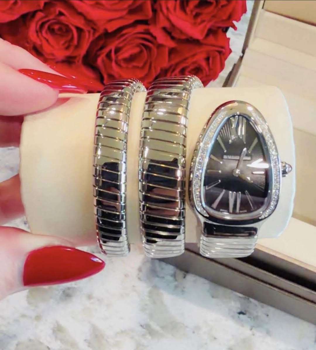 May be an image of wrist watch and jewelry