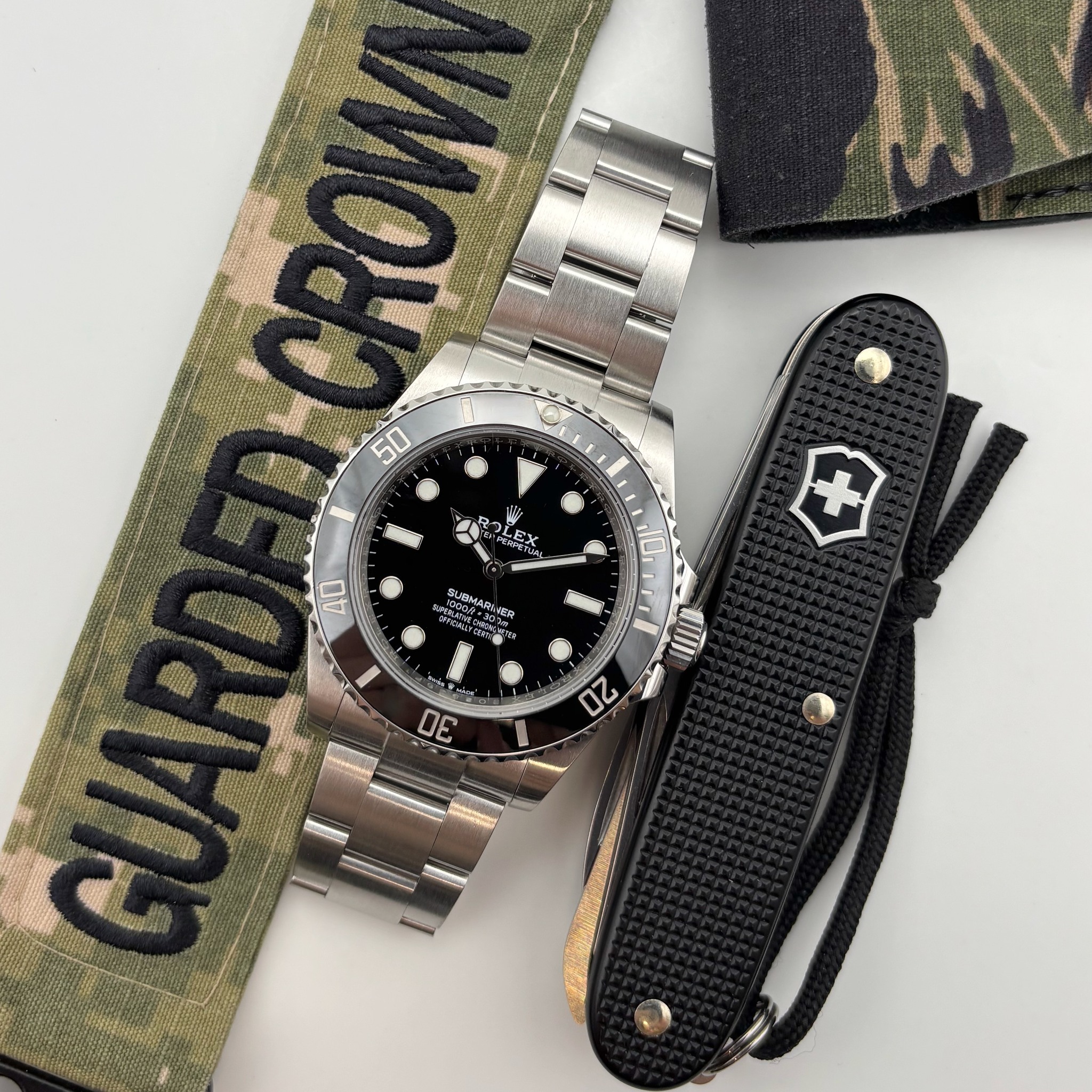 May be an image of wrist watch, knife and text