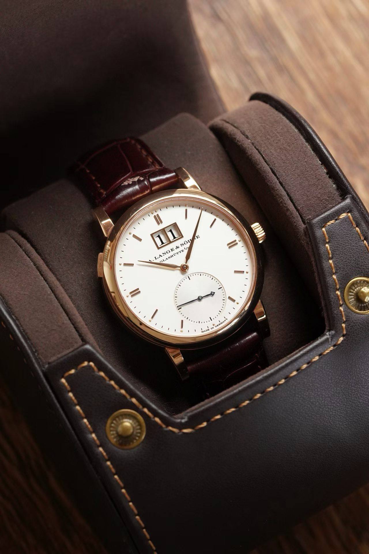 May be an image of wrist watch, leather and text