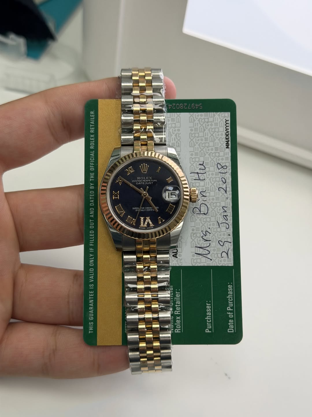 May be an image of wrist watch and text that says 'ILER RETAILER RETA ROLEX ICIAL EOF OFF He 人C/HH IA FILLED ONL VALID GUARANT THIS Retailer Rolex DateofPurchase: of Purchase…