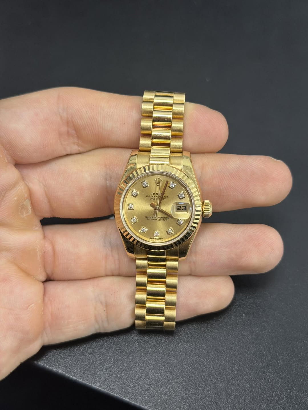 May be an image of wrist watch and text