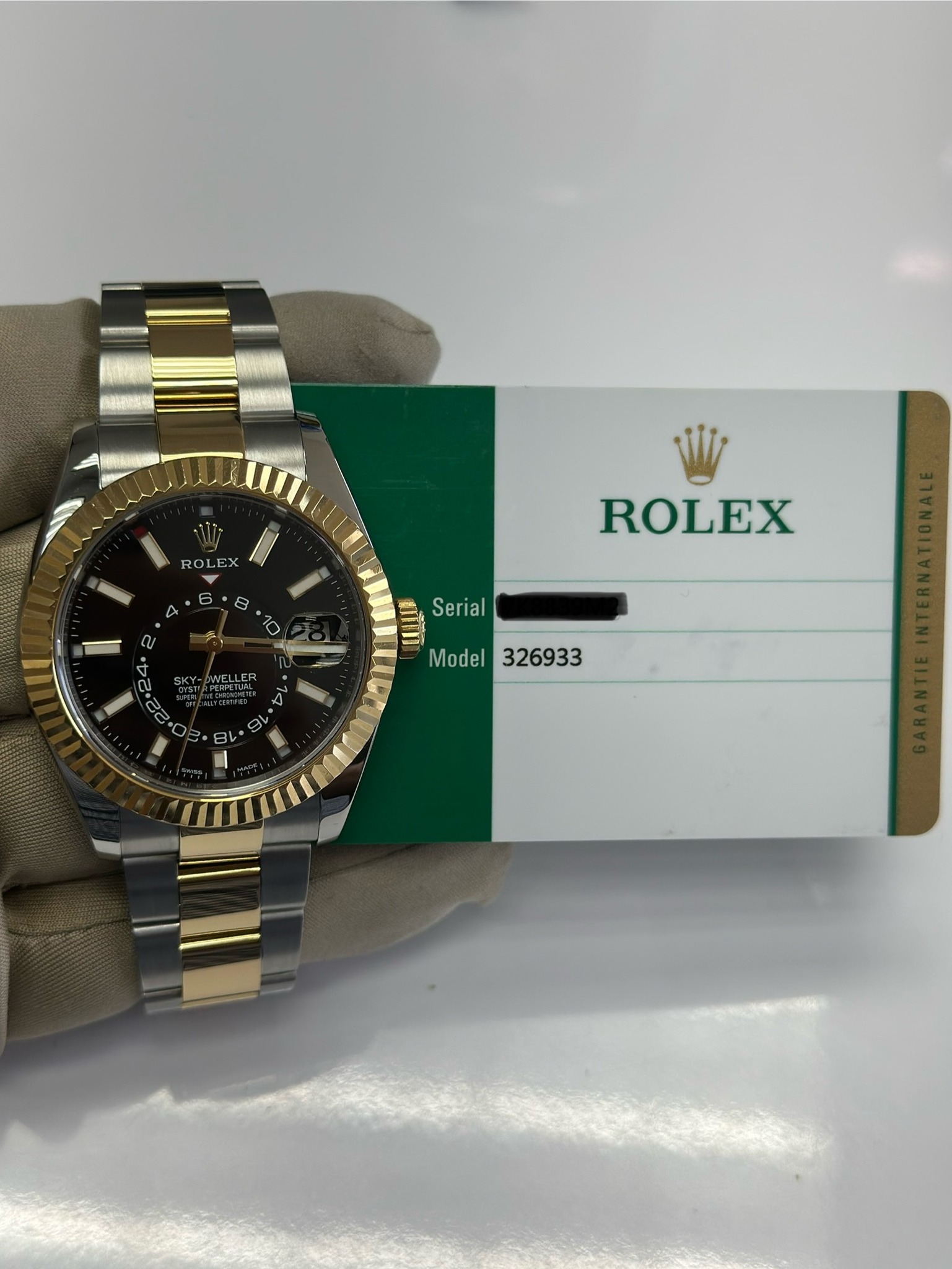 May be an image of wrist watch and text that says '.تاا ROL EX E 6 A 2 8 10 ROLEX Serial SKY- WELLEN ER Model Model326933 eV OL'