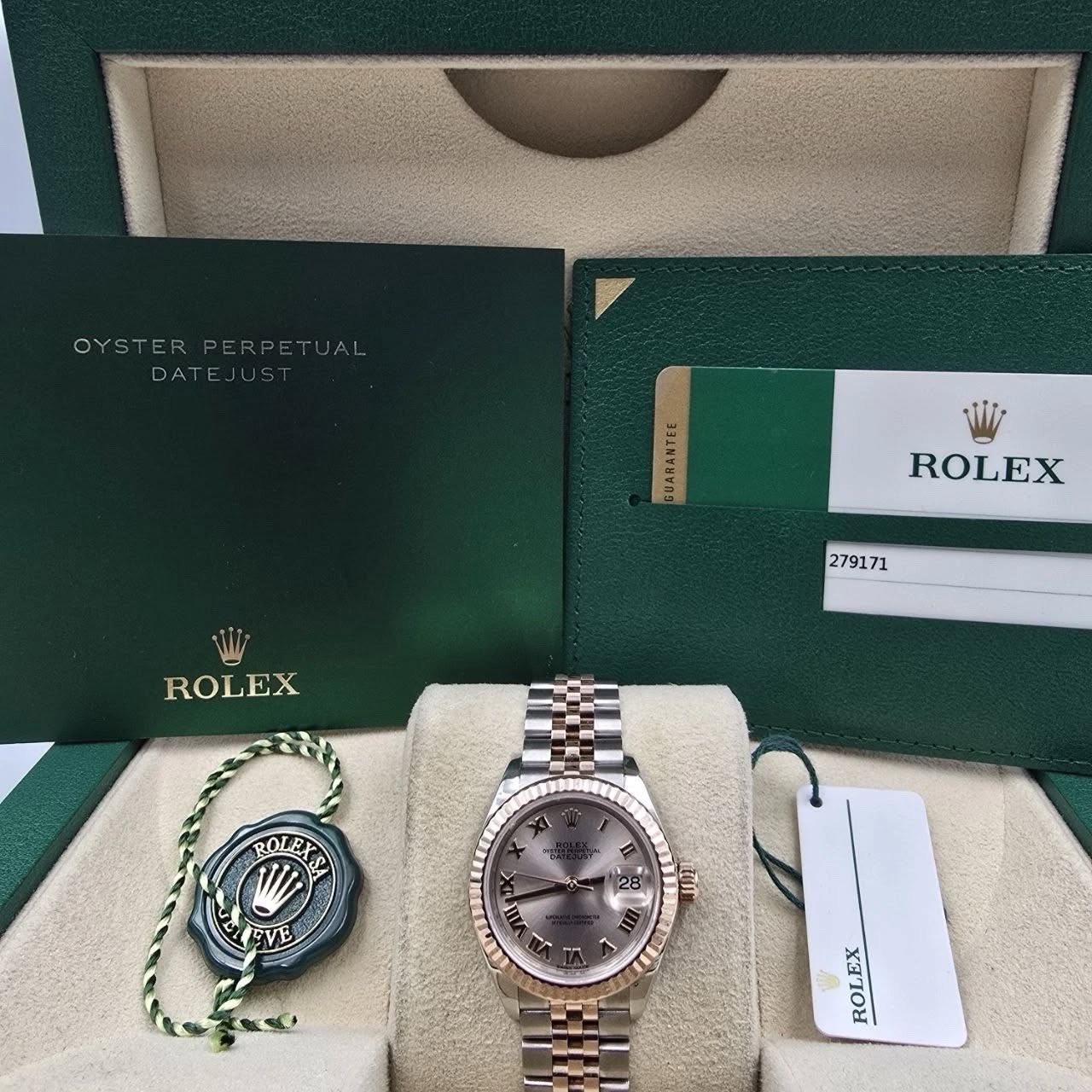 May be an image of wrist watch and text that says 'OYSTERPERPETUAL DATEJUST EJUS DATE SUARANTEL ROLEX 279171 ROLEX ROLEX EVE O 重 a A எம III u ROLEX'
