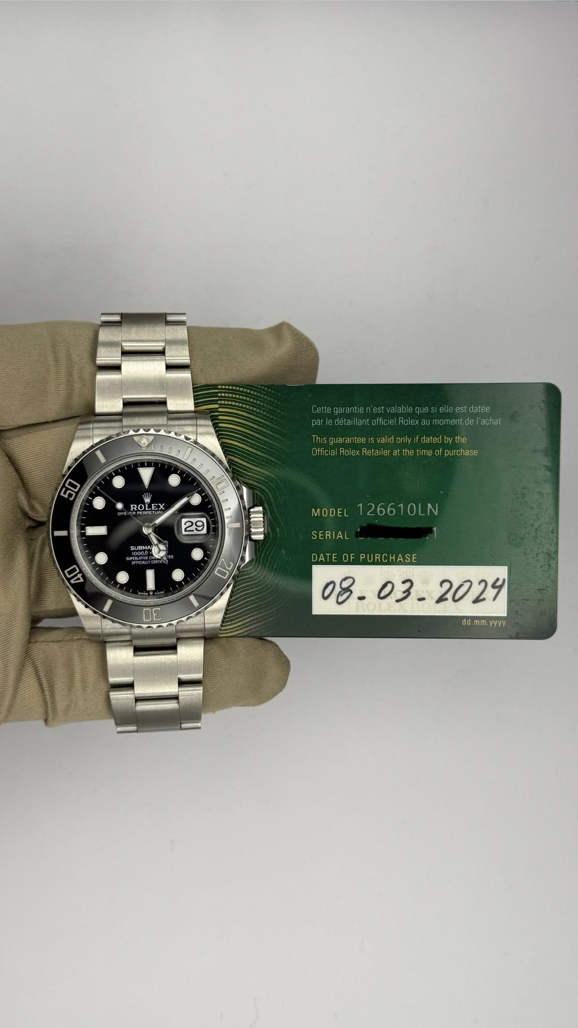 May be an image of wrist watch and text that says '50 OLE 29 MODEL MODEL126610LN 126610LN AO FUSS 20 00 DATEOFPURCHASE VYY'