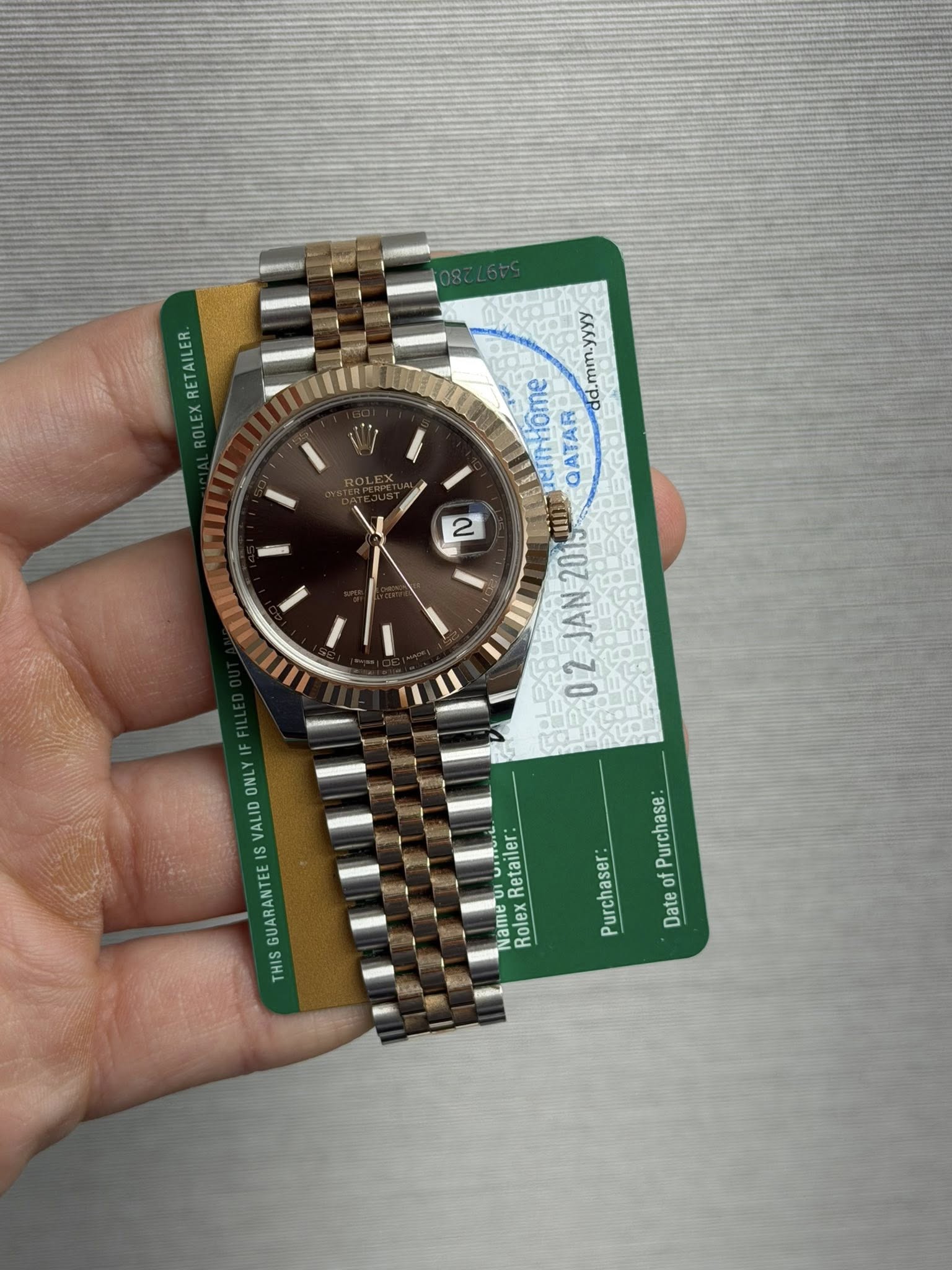 May be an image of wrist watch and text that says 'ETAILER RE dd.mm.yyyy erntiome QATAR 2 2019 JAN O 02 2JAN2019 2 ONL ISGUARANTEEISVAL IS VALID SGUARANTE THIS Purchase: Purchaser…
