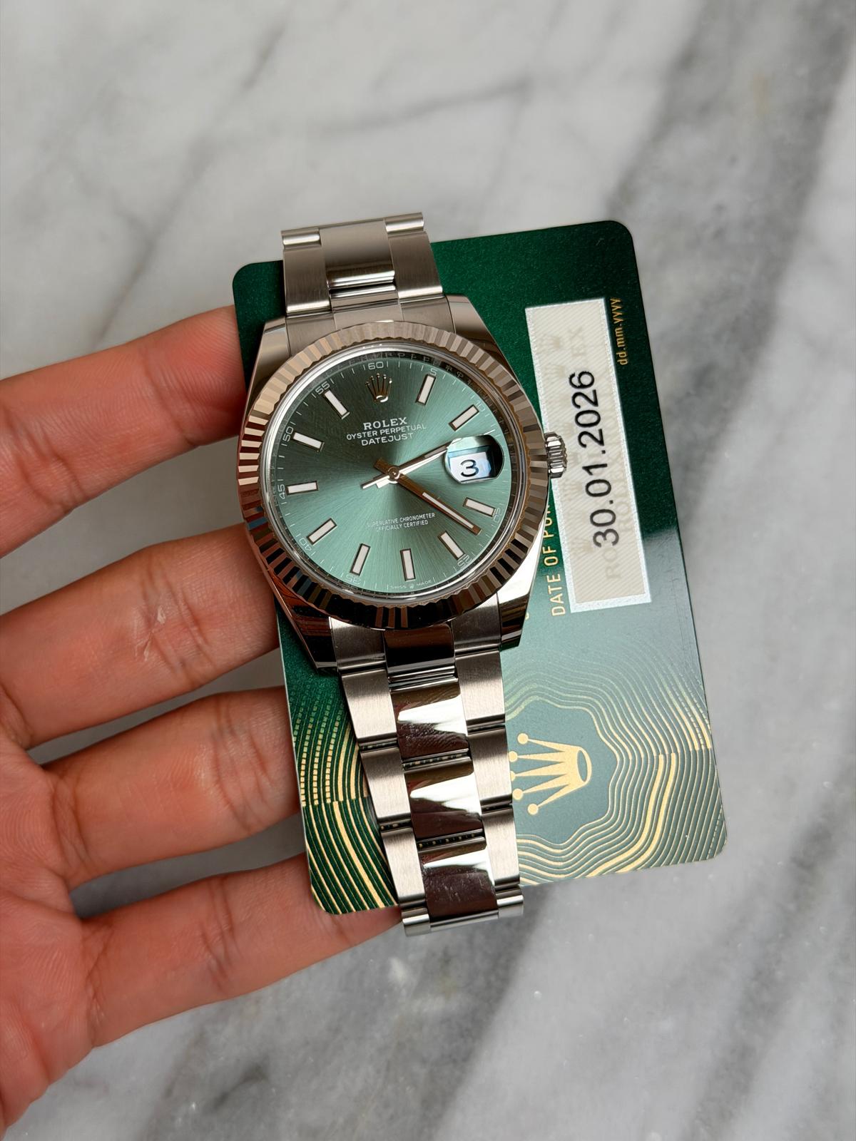 May be an image of wrist watch and text that says '60 ROLEX CYSTE PERIP D BAT ATE STERPERPETU UST I 3 HIII I MPUrea - I dd.mm.yvyy 2026 01 Fo OF MRUIND DATE'