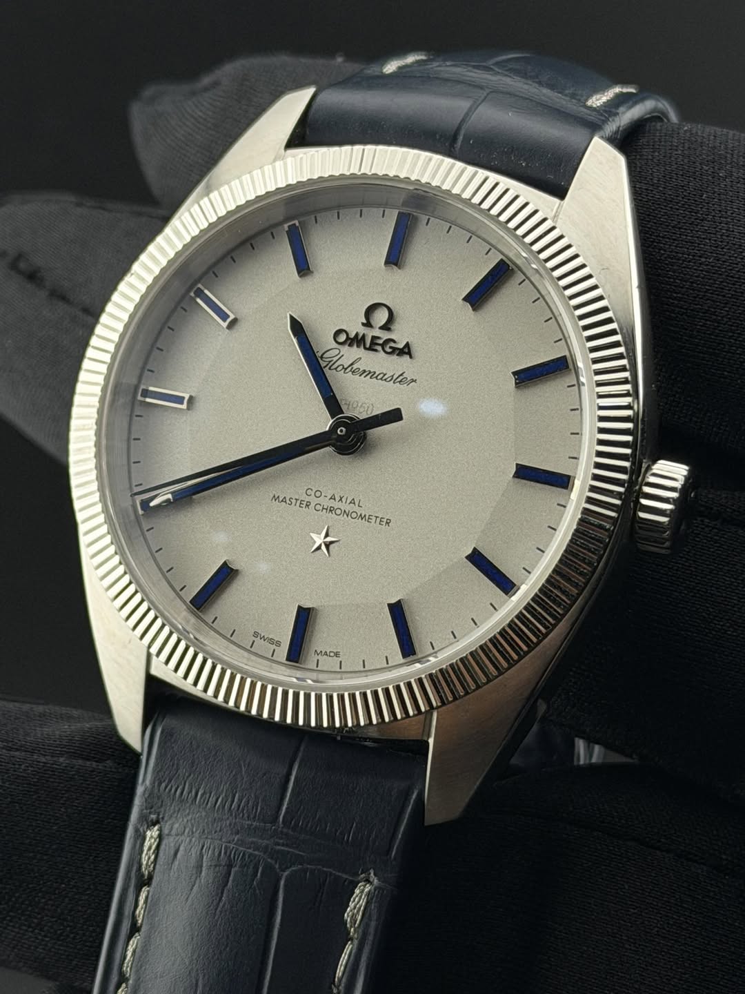May be an image of wrist watch and text that says 'Globemaster OMEGA QMEGA OMEGA MASTER MASTERCHRONOMETER CO O-AXIAL CHRONOMETER WISS MADE'