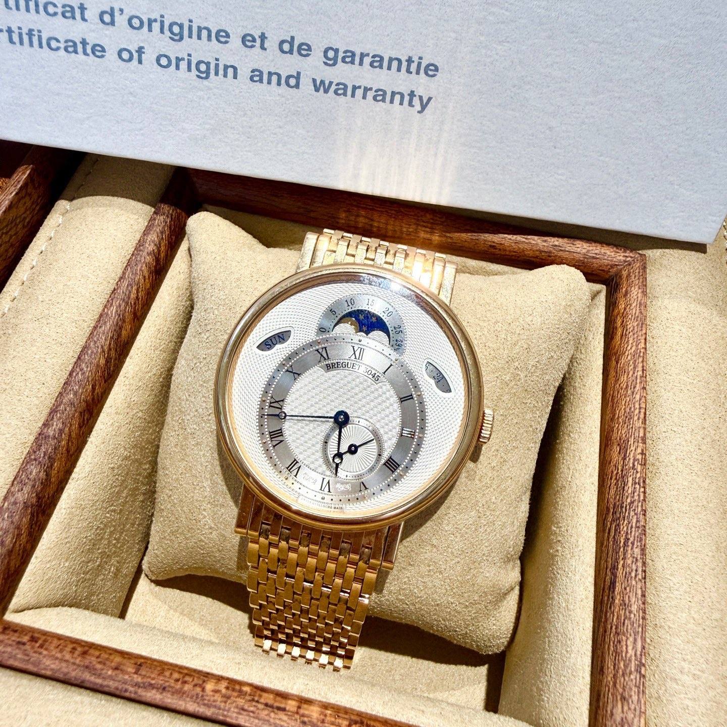 May be an image of wrist watch and text that says 'micat d' origine et tificate of origin and de garantie warranty XI BREIUES Mge I MLE สนทง IA E 7'