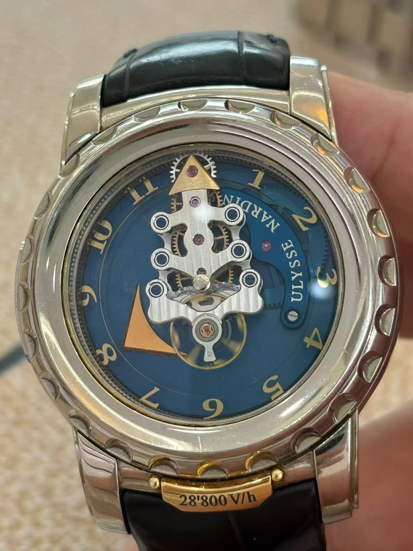 May be an image of wrist watch and text