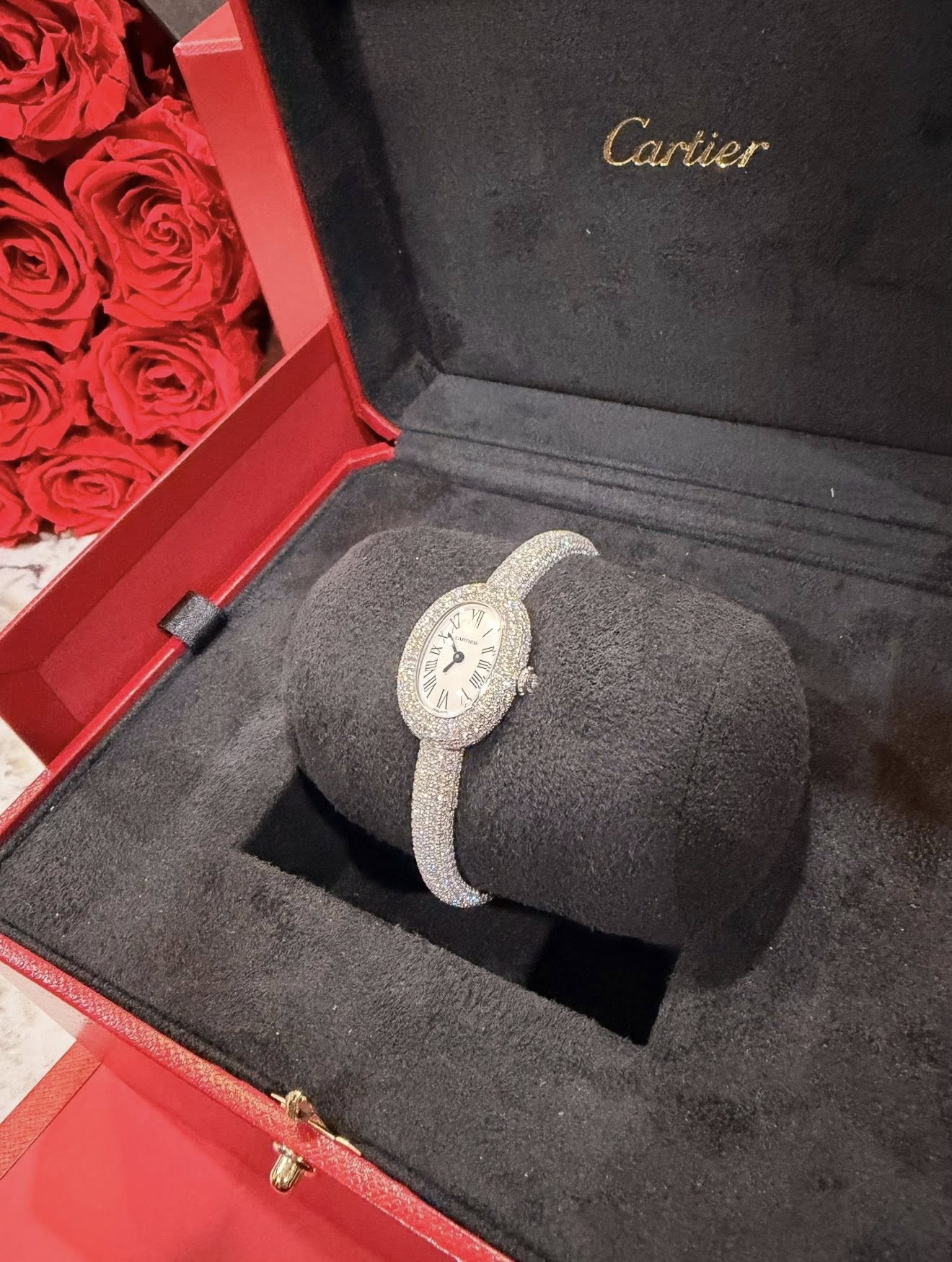 May be an image of wrist watch, ring and text that says 'Cartier ካ'