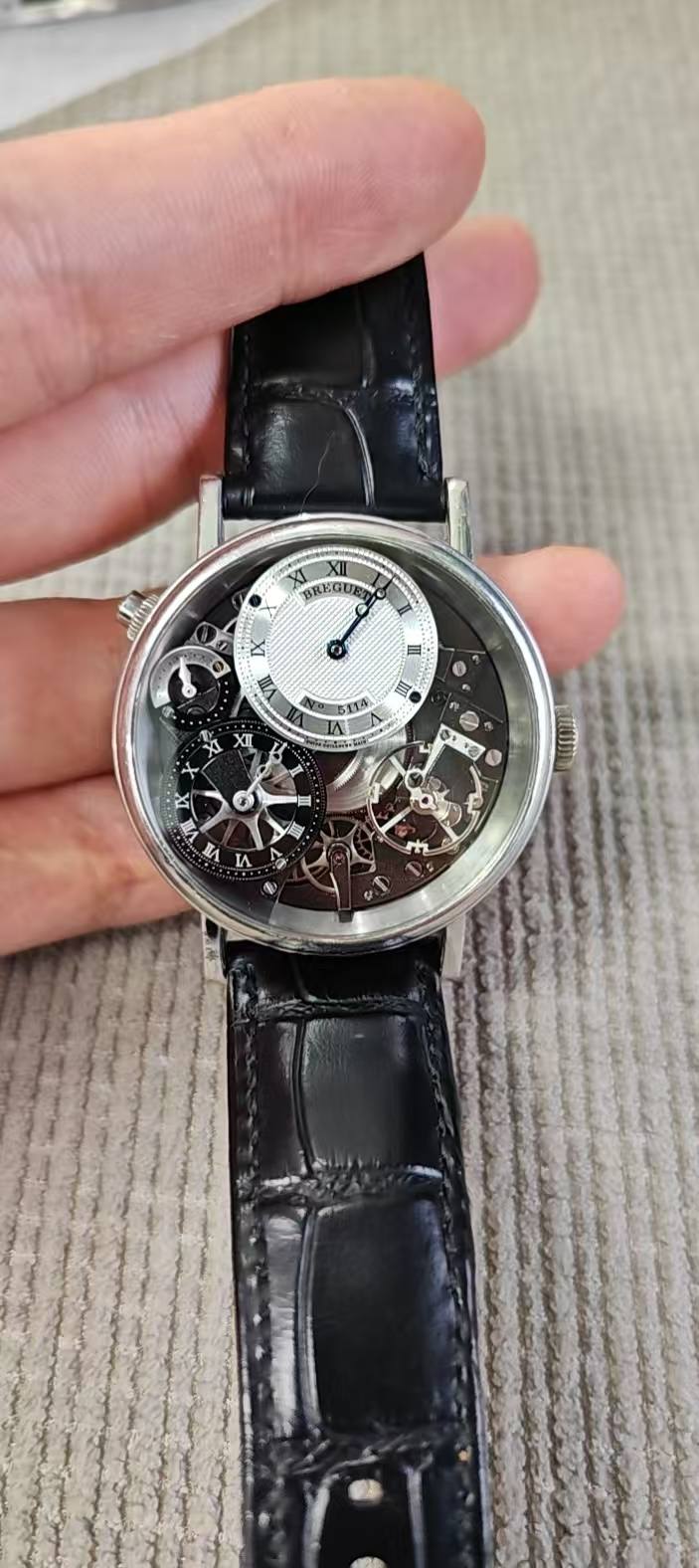 May be an image of wrist watch and text
