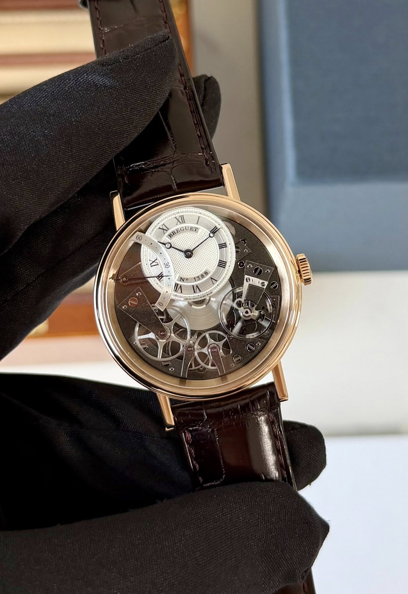 May be an image of wrist watch and text that says '8 XII XI BREGUET Ο I IX 00 I N 1383 IA O1 HIIIN 10'