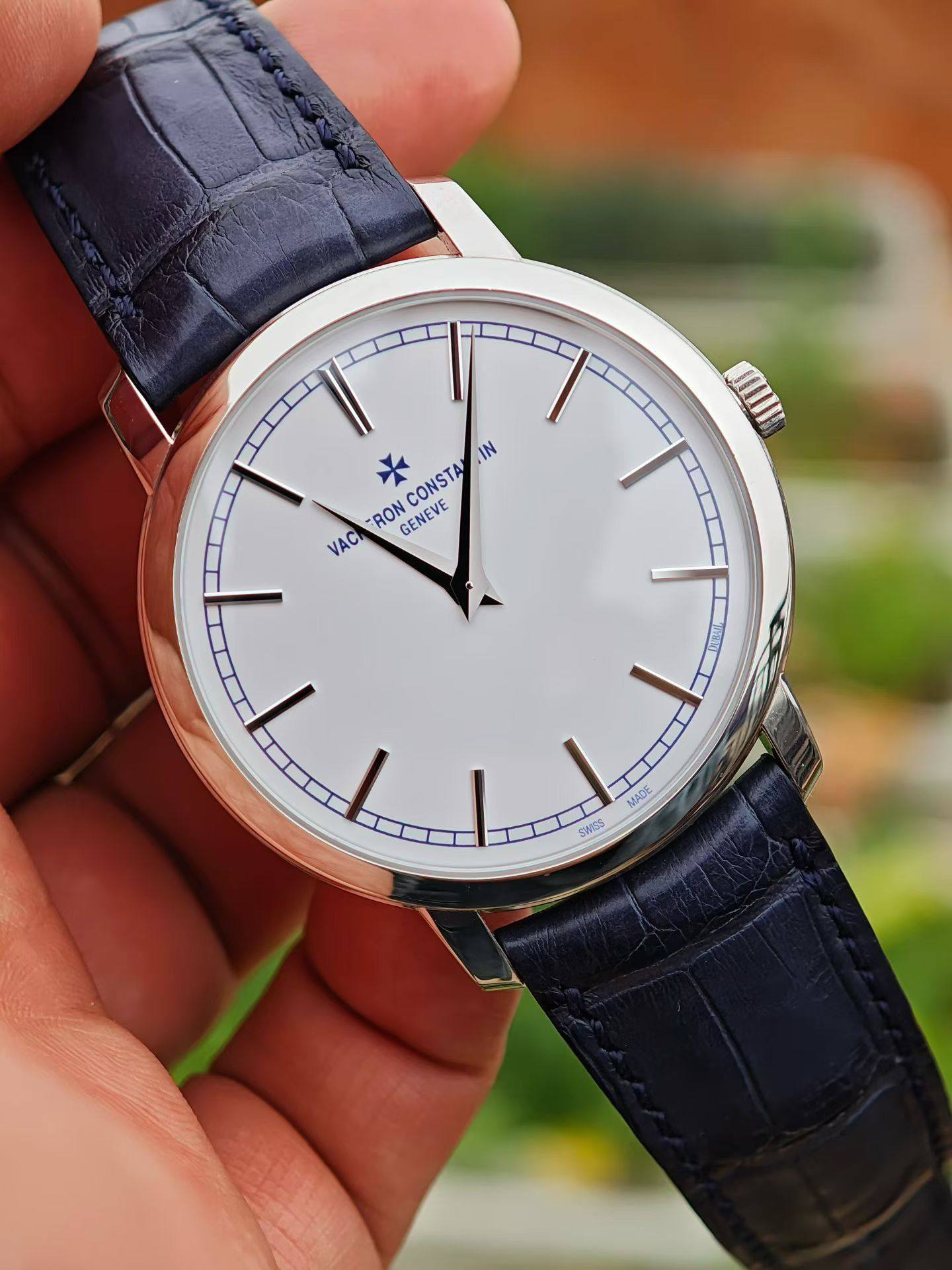 May be an image of wrist watch and text that says 'IN CONSTA RON GENEVE VACI MADE SWISS'